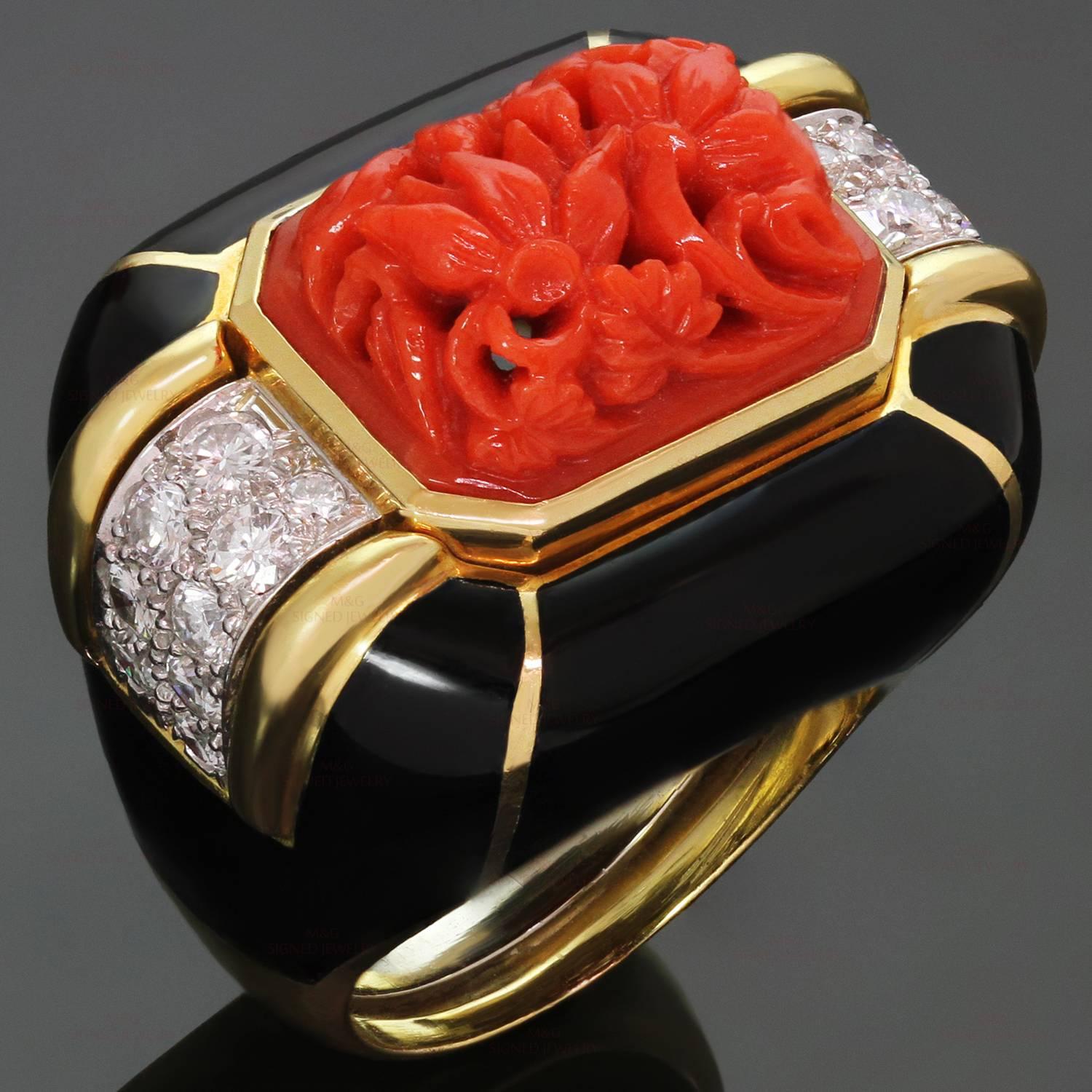 This gorgeous David Webb ring is crafted in 18k yellow gold and platinum and features natural oxblood coral beautifully carved into a floral design and accented with black enamel sides and brilliant-cut round diamonds of an estimated 0.90 carats.