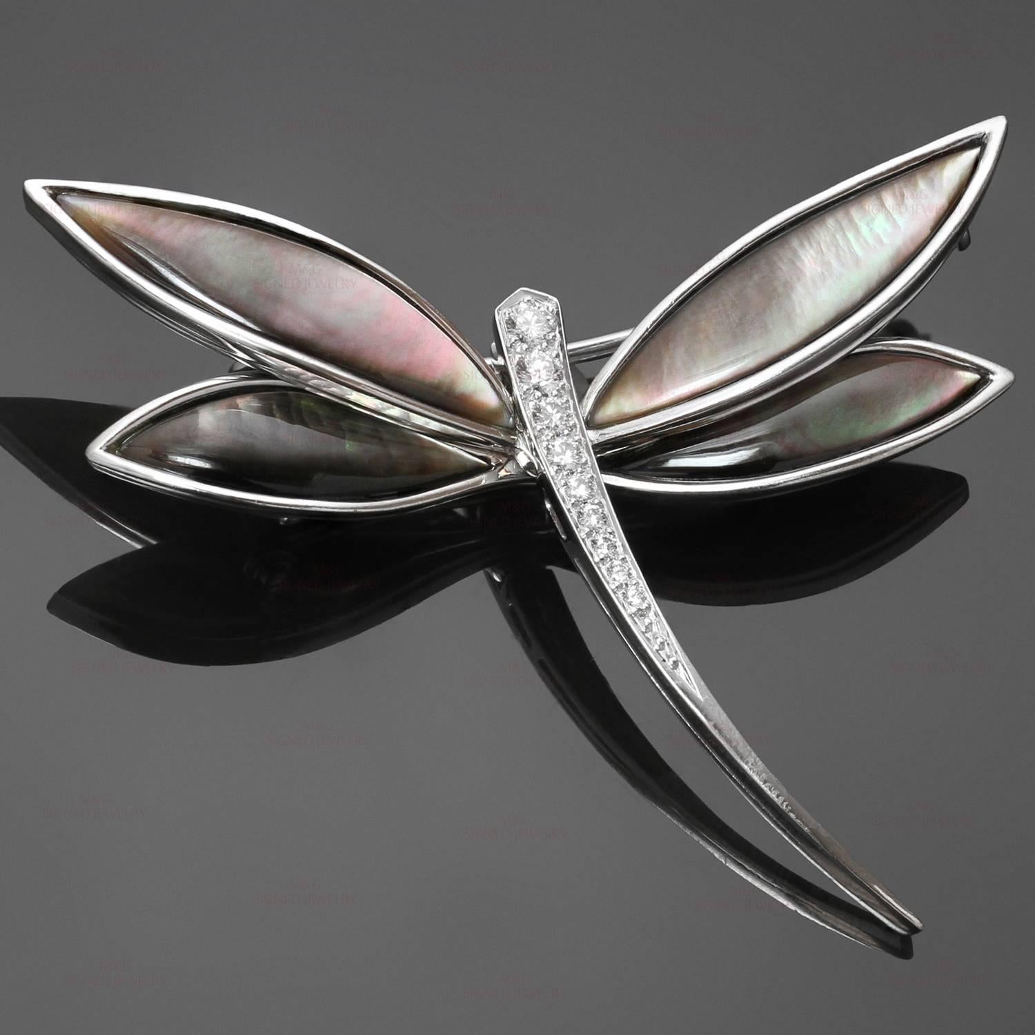 This iconic Van Cleef & Arpels brooch features a dragonfly design crafted in 18k white gold and accented with a sparkling brilliant-cut diamonds of an estimated 0.15 carats and grey mother-of-pearl wings. Made in France circa 2000s.