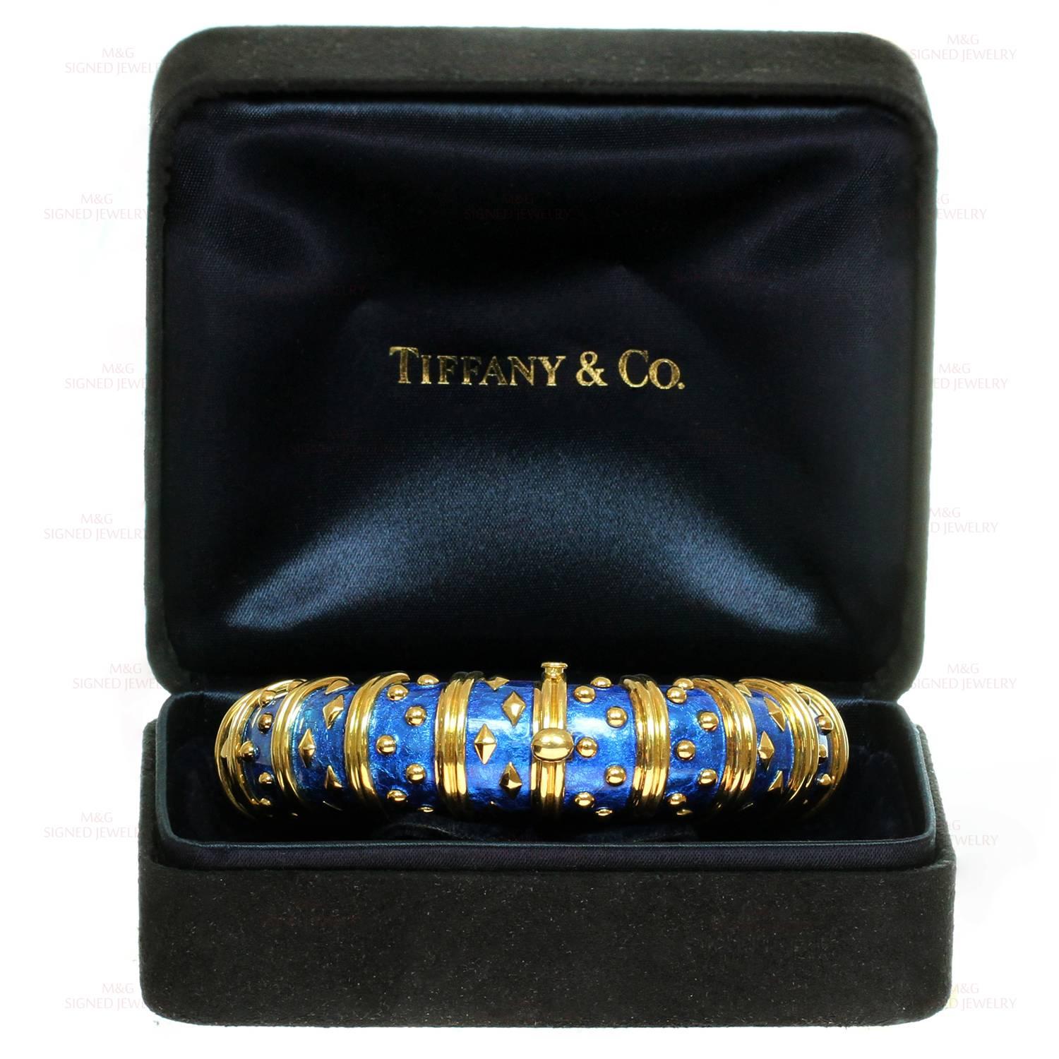 This iconic Tiffany bracelet was designed by Schlumberger for the dazzling Dot Losange collection. The bangle is crafted in 18k yellow gold and beautifully inlaid with blue enamel. Made in United States circa 2000s. Measurements: 0.70" (18mm)