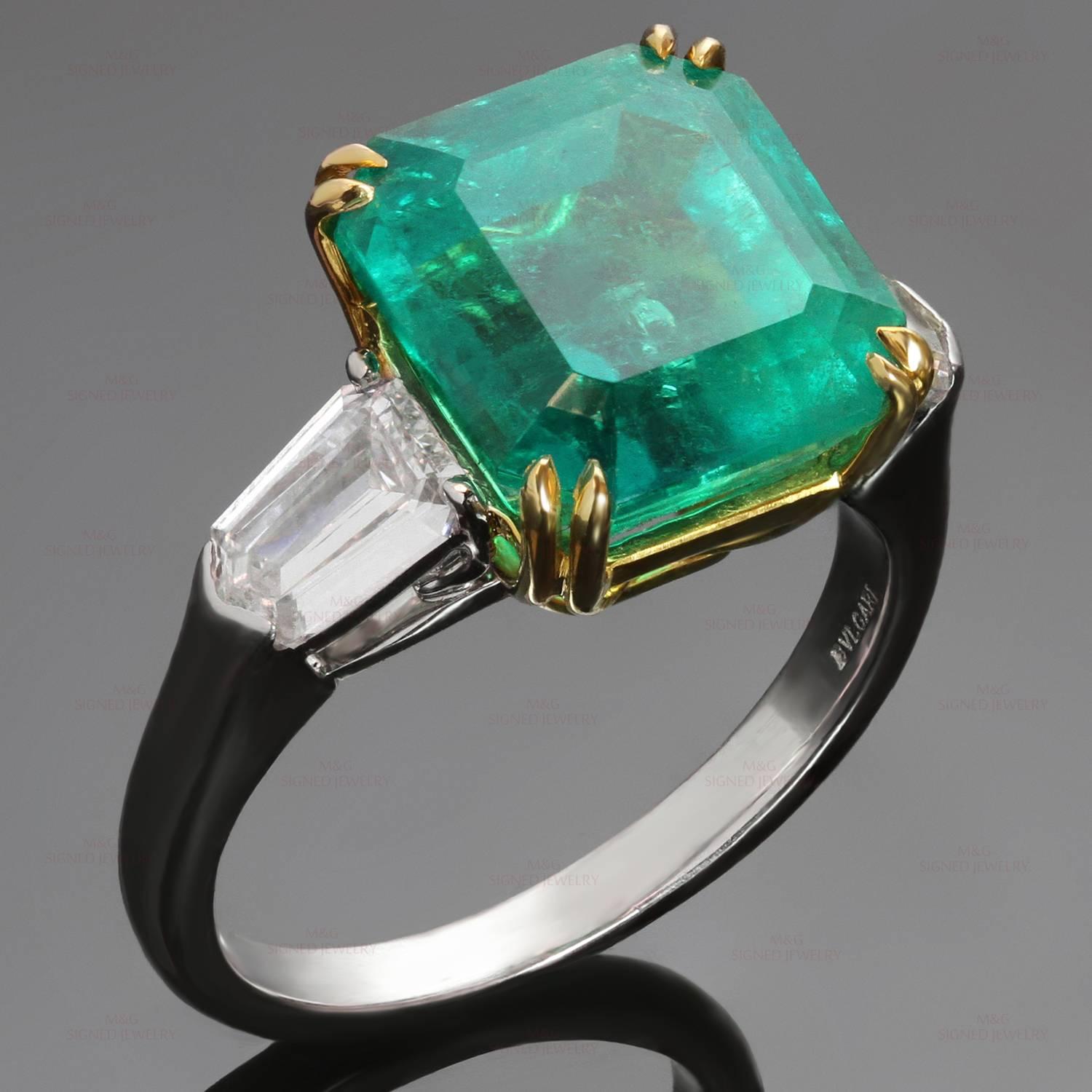 This gorgeous Bulgari ring is crafted in platinum and features an octagonal step-cut Colombian emerald weighing 6.13 carat, set in 18k yellow prongs flanked by 2 shield-cut diamonds measuring 6.00 x 4.20 x 2.15 mm and weighing an estimated 0.90
