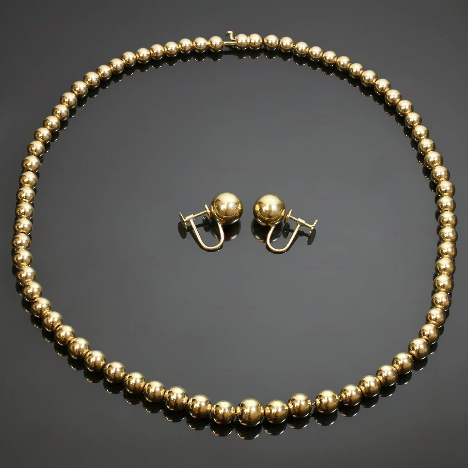 This vintage Tiffany & Co. consists of necklace and a matching pair of earrings featuring a classic bead design crafted in 14k yellow gold. Made in United States circa 1980s. Measurements: 0.38