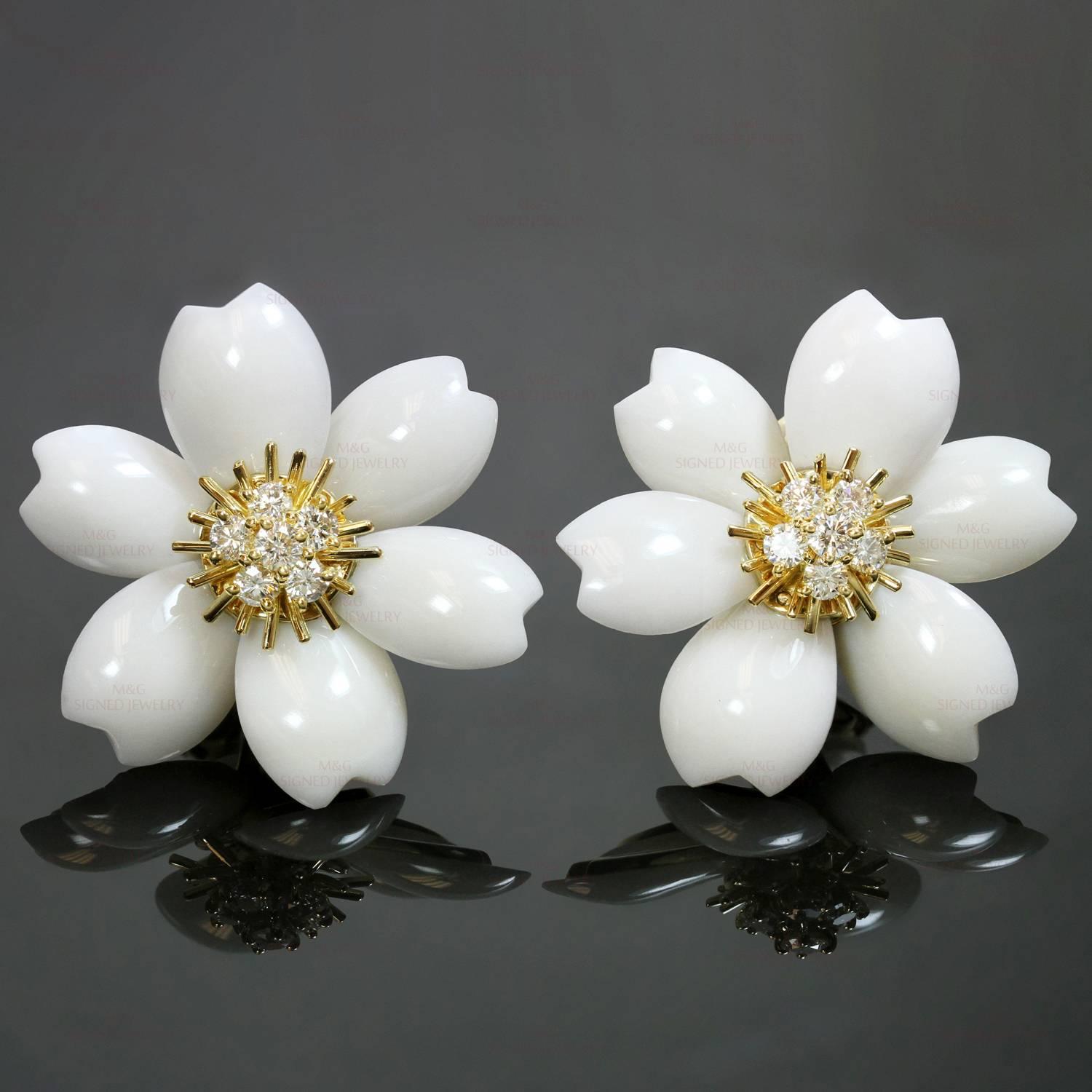 These gorgeous Van Cleef & Arpels clip-on earrings from the Rose de Noel collection are crafted in 18k yellow gold and feature a delicate flower design composed of natural white coral petals and completed with sparkling centers prong-set with