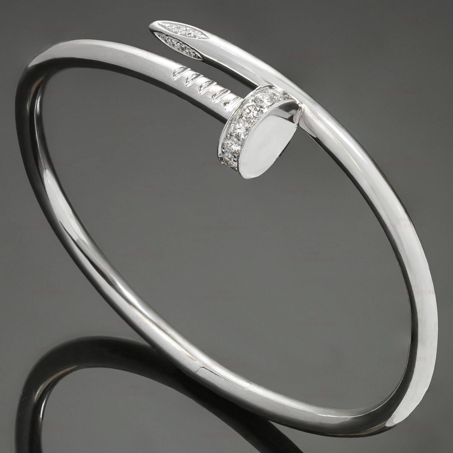 This fabulous hinged bangle from Cartier's Juste Un Clou collection is made in 18 white gold and pave-set brilliant-cut round diamonds of an estimated 0.54 carats. This bracelet is a size 17. Made in France circa 2000s. . 