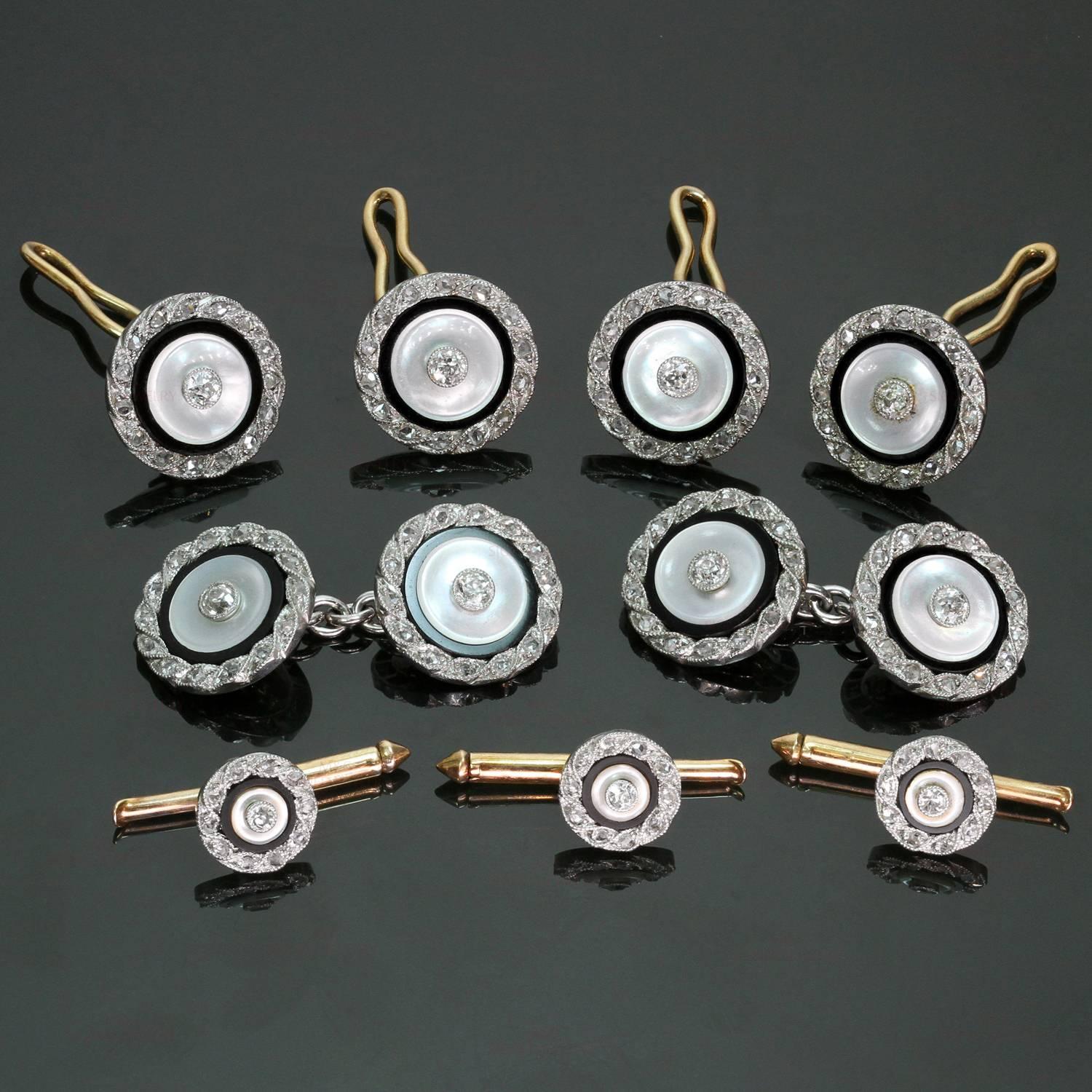 This fabulous Edwardian dress set Dreicer consists of a pair of cuff-links, a quartet of vest studs and a trio of shirt studs crafted in 14k yellow gold and features discs of black onyx and mother-of-pearl studded in the center with round diamonds