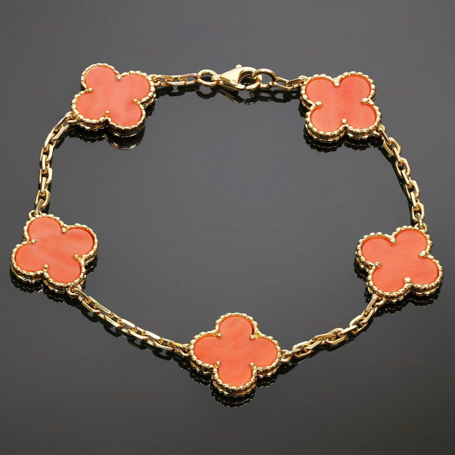 This rare out-of-production Van Cleef & Arpels bracelet is crafted in 18k yellow gold and features 5 lucky clover motifs beautifully inlaid with coral in round bead settings. Made in France circa 2000s. Measurements: 0.55