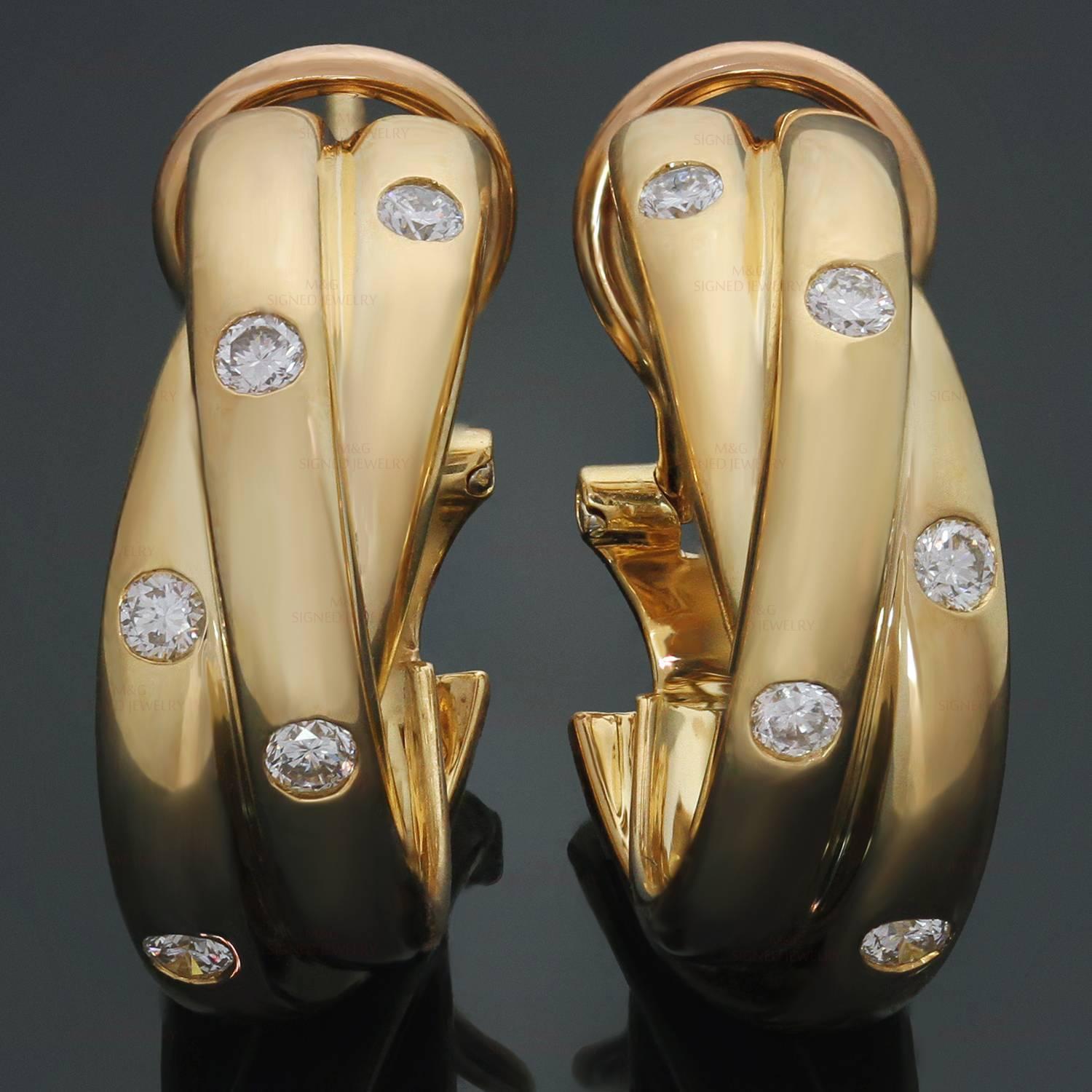 These fabulous earrings from Cartier's Trinity collection feature the classic twisted cable design crafted in 18k yellow gold and bezel-set with brilliant-cut round diamonds. Made in France circa 1990s. Iconic and timeless. Measurements: 0.23"