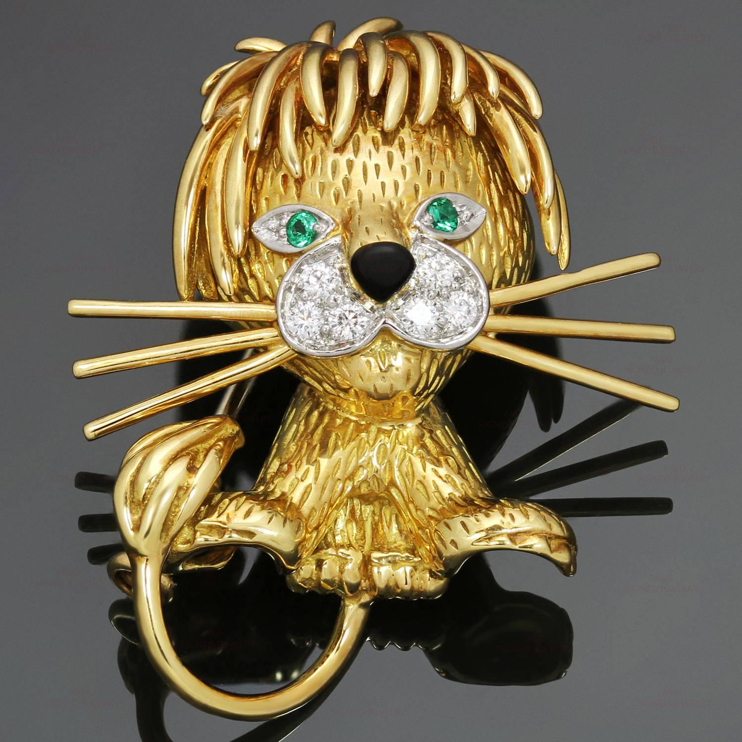 This iconic Van Cleef & Arpels brooch features a fabulous lion design crafted in 18k yellow gold and accented with sparkling brilliant-cut diamonds, green emerald eyes, and a black enamel nose. This is the rare small size model of the brooch.