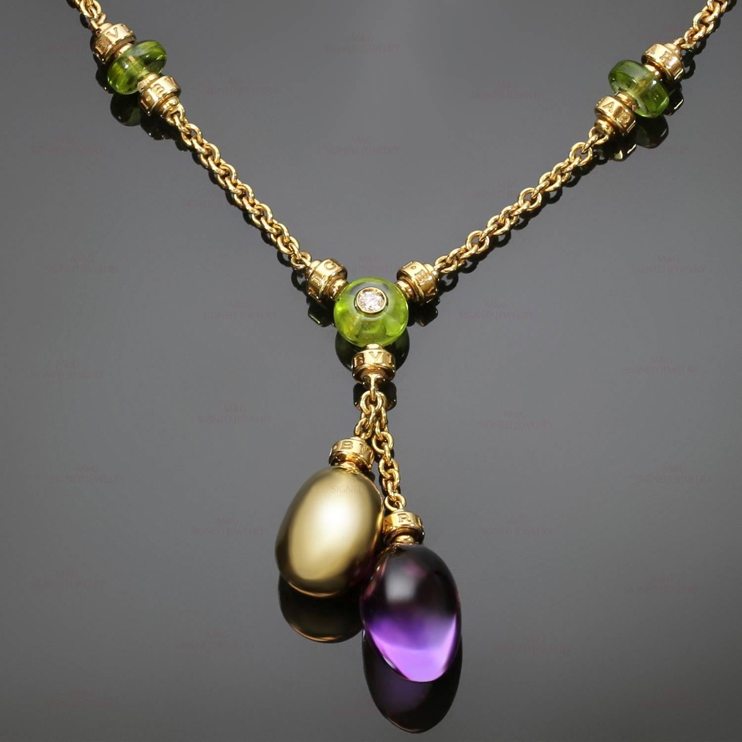 This fabulous Bulgari necklace from the chic Sassi collection is crafted in 18k yellow gold and accented with a solitaire brilliant-cut round diamond, cabochon peridots, and a cabochon amethyst pendant drop. Made in Italy circa 2000s. Measurements: