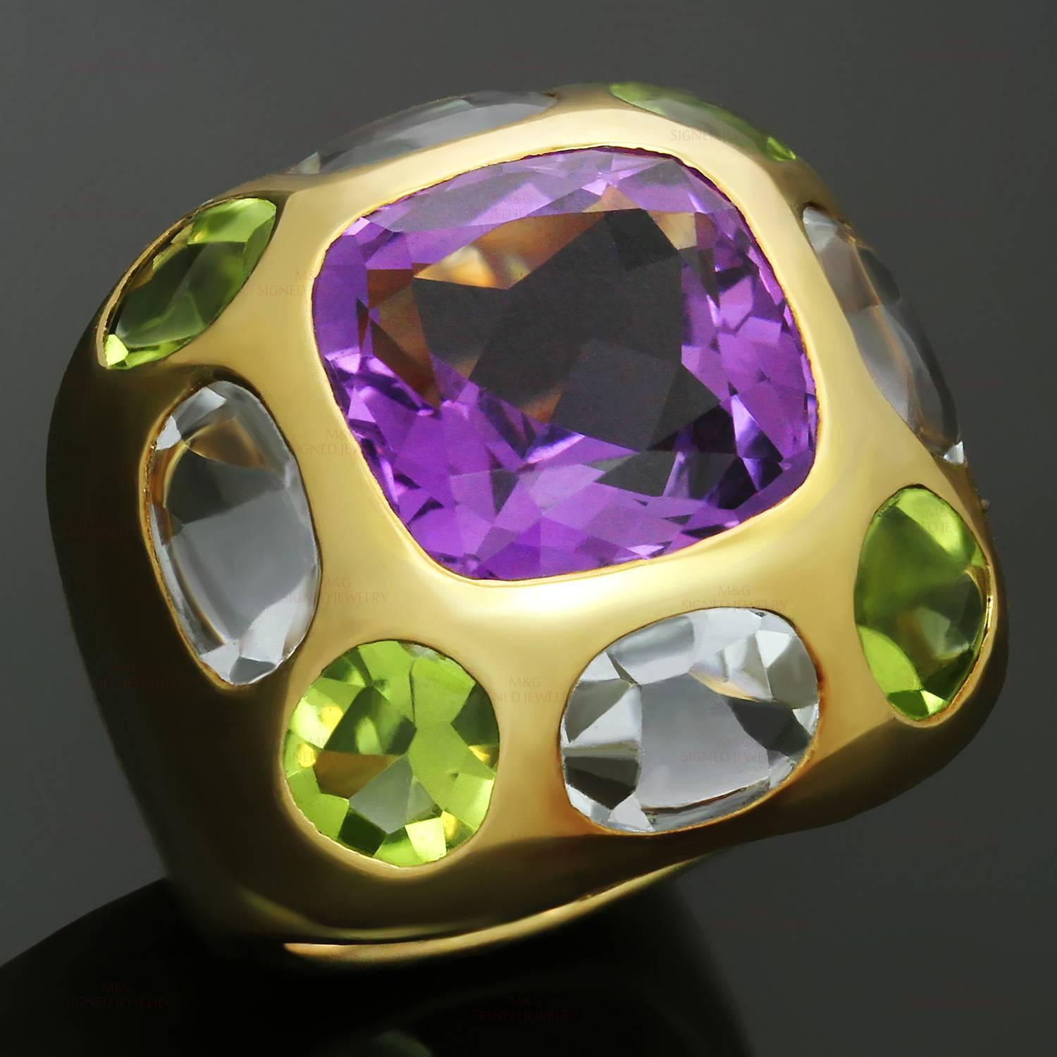 This chic Chanel dome ring from the vibrant Baroque collection is crafted in 18k yellow gold and features a faceted amethyst in the center surrounded by 4 oval peridots and 4 oval aquamarines. Made in France circa 2010s. Measurements: 0.78