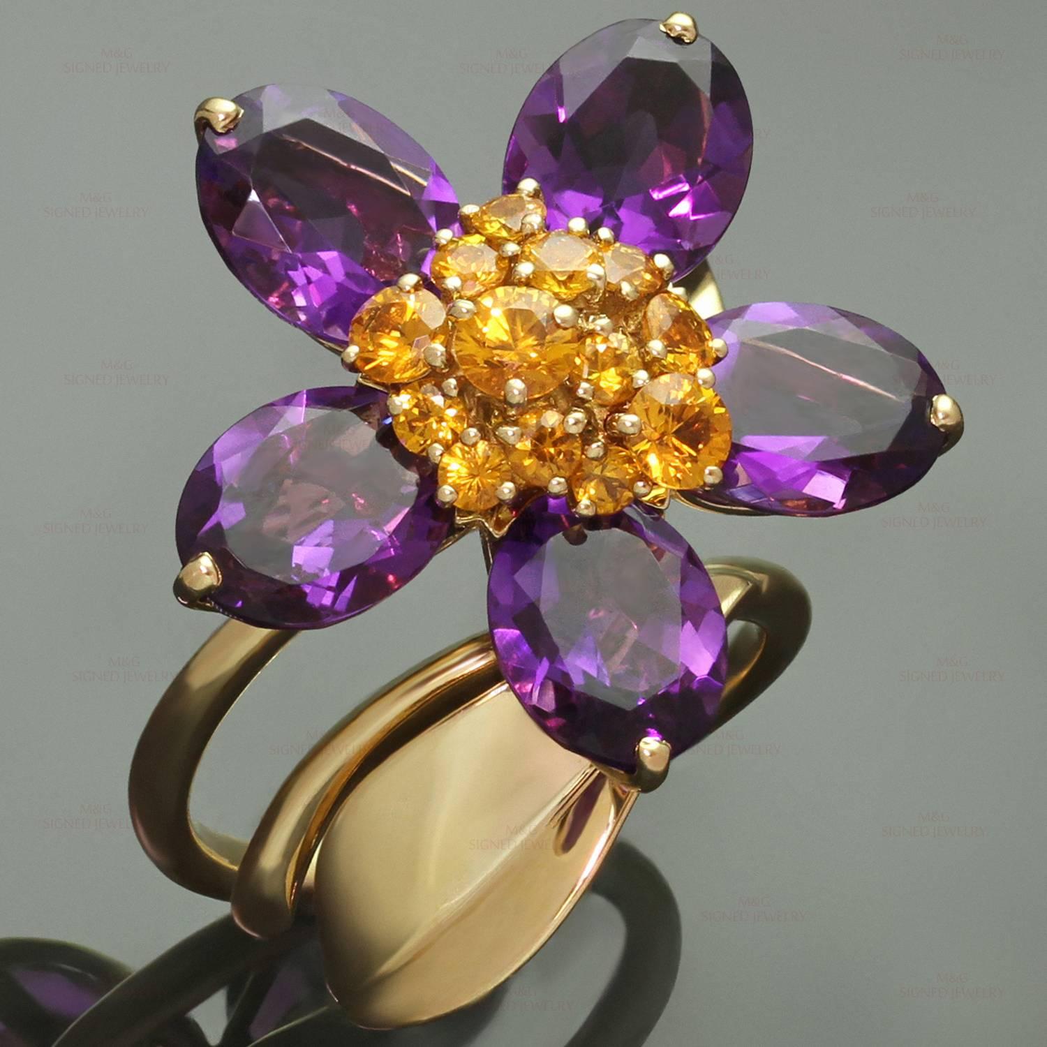 This stunning Van Cleef & Arpels ring from the vibrant Hawaii collection is made in 18k yellow gold and features an open band accented with a leaf and a rotatable flower composed of 5 faceted amethyst petals and a cluster of faceted orange