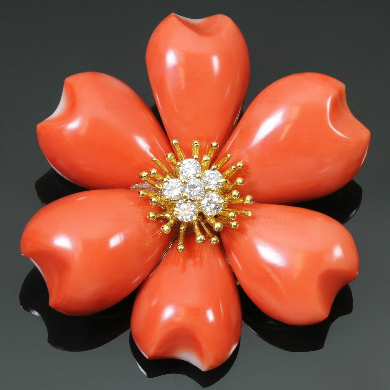 This gorgeous Italian brooch is crafted in 18k yellow gold and features a flower-shaped design with natural carved red coral petals and a sparkling center of full-cut diamonds weighing an estimated 0.30 carats. Measurements: 1.61" (41mm) width. 