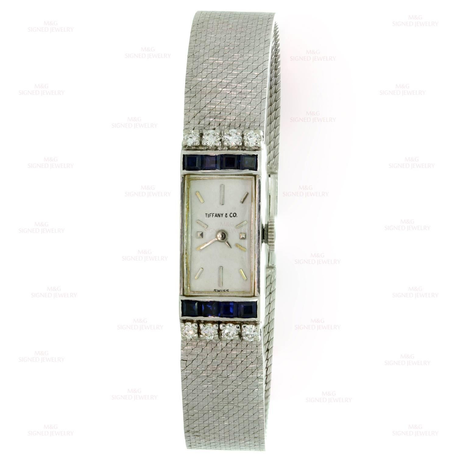 This stunning Tiffany vintage women's watch is crafted in 14k white gold and features a rectangular case accented with blue sapphires of an estimated 0.40 carats and brilliant-cut round diamonds of an estimated 0.32 carats. The mechanical hand wind