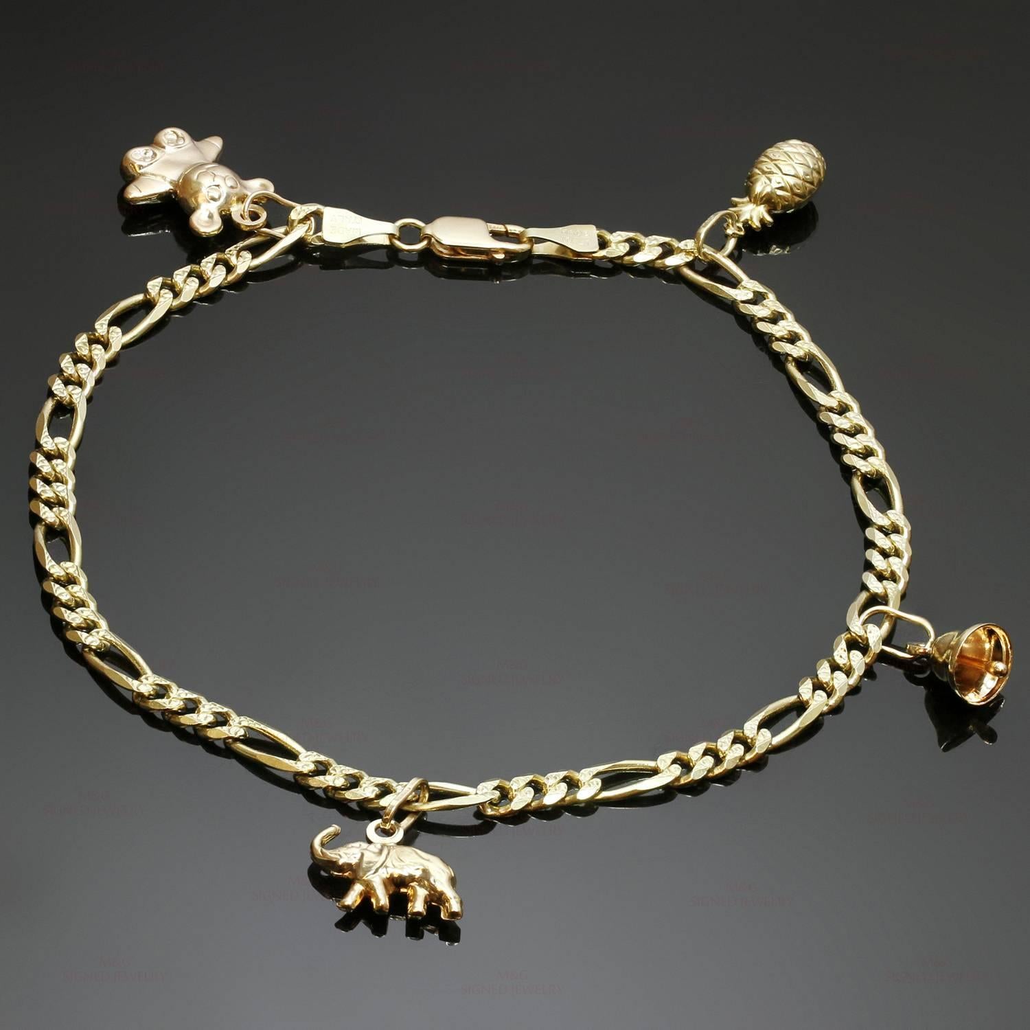 This ankle bracelet is crafted in 14k yellow gold and features 4 charms - an elephant, a pineapple, a teddy bear, and a jingle bell. Made in Italy circa 1990s. Measurements: 0.15" (4mm) width, 10" (25.4cm) length. 