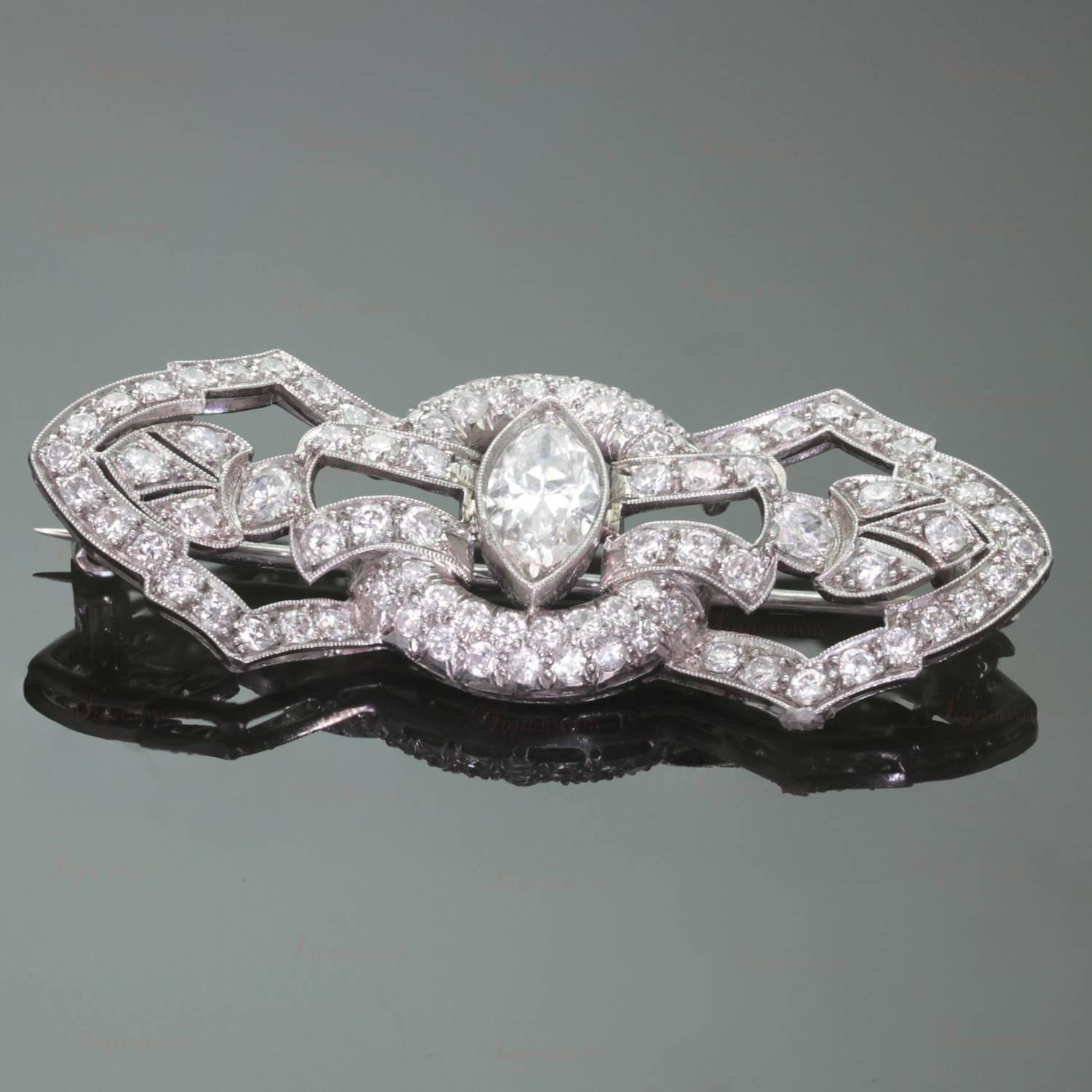 This stunning Art-Deco brooch is hand-made in platinum and features a filigree design with a very clean and white marquise-cut diamond of approximately 1 carat in the center, surrounded by 89 old-cut diamonds of an estimated 2.25 carats. There is no
