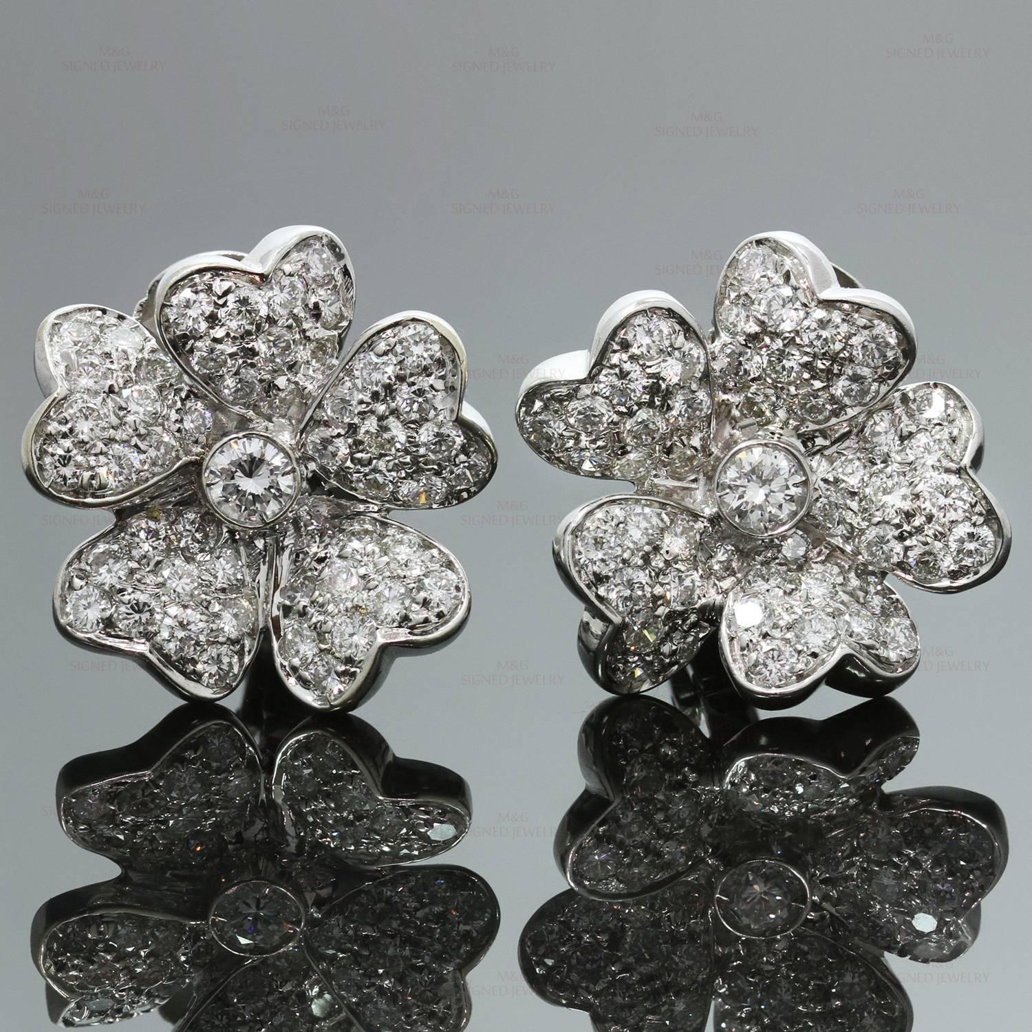 These exquisite modern earrings feature a sparkling 5-petal flower design crafted in 18k white gold and set with brilliant-cut diamonds of an estimated 3.70 carats. Made in italy circa 2000s. Measurements: 0.78" (20mm) width. 
