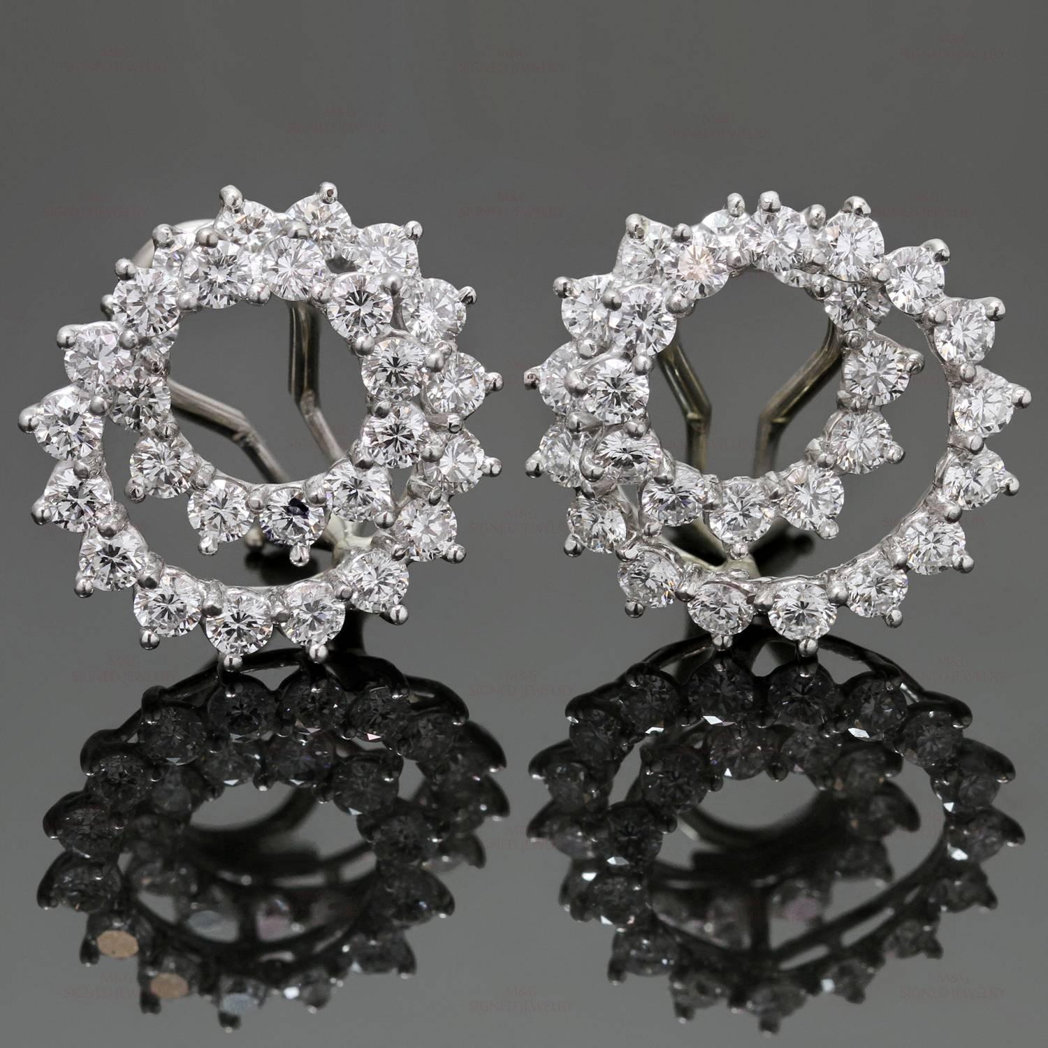 These sparkling Tiffany clip-on earrings feature an iconic swirl design crafted in platinum and set with brilliant-cut round diamonds of an estimated 5.0 carats. Made in United States circa 1950s. Measurements: 0.78" (20mm) width, 0.78"
