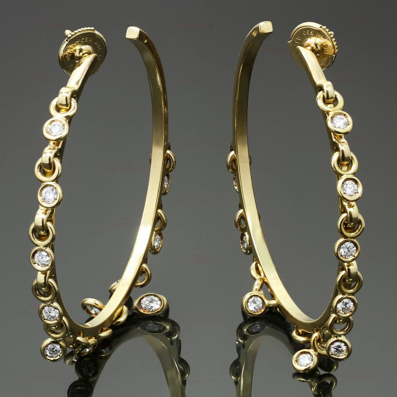 These gorgeous Christian Dior hoop earrings are crafted in 18k white gold and feature dangling hoops bezel-set with brilliant-cut round diamonds of an estimated 1.20 carats. Made in France circa 2000s. Measurements: 1.73" (44mm) length. 