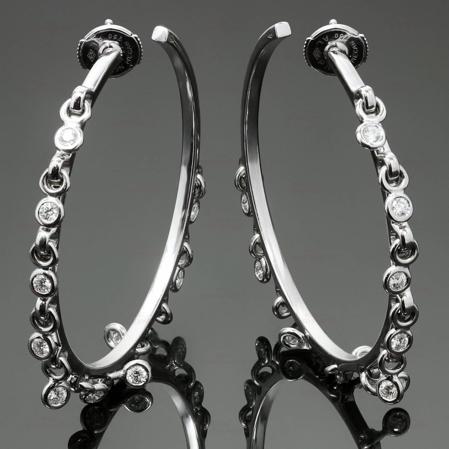 These gorgeous Christian Dior hoop earrings are crafted in 18k white gold and feature dangling hoops bezel-set with brilliant-cut round diamonds of an estimated 1.20 carats. Made in France circa 2000s. Measurements: 1.73