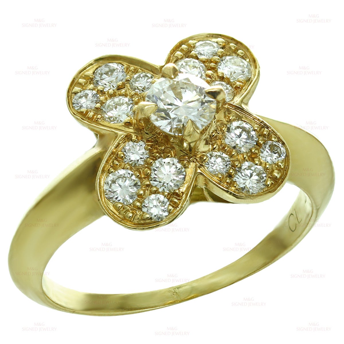 This stunning Van Cleefs & Arpels ring from the classic Trefle collection is made in 18k yellow gold and features a clover motif set with brilliant-cut round E-F VVS2-VS1 diamonds of an estimated 0.50 carats. Made in France circa 1990s.