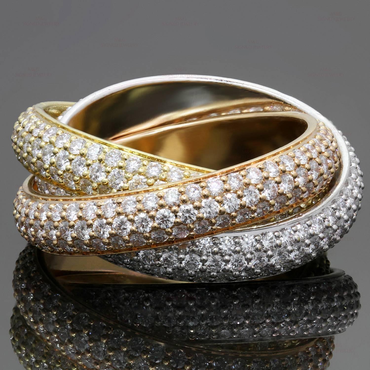 This iconic ring from Cartier's Trinity collection features 3 interconnected bands crafted in 18k yellow, white and rose gold and pave-set with brilliant-cut round diamonds of an estimated 2.98 carats.  Made in France circa 2000s. Measurements: