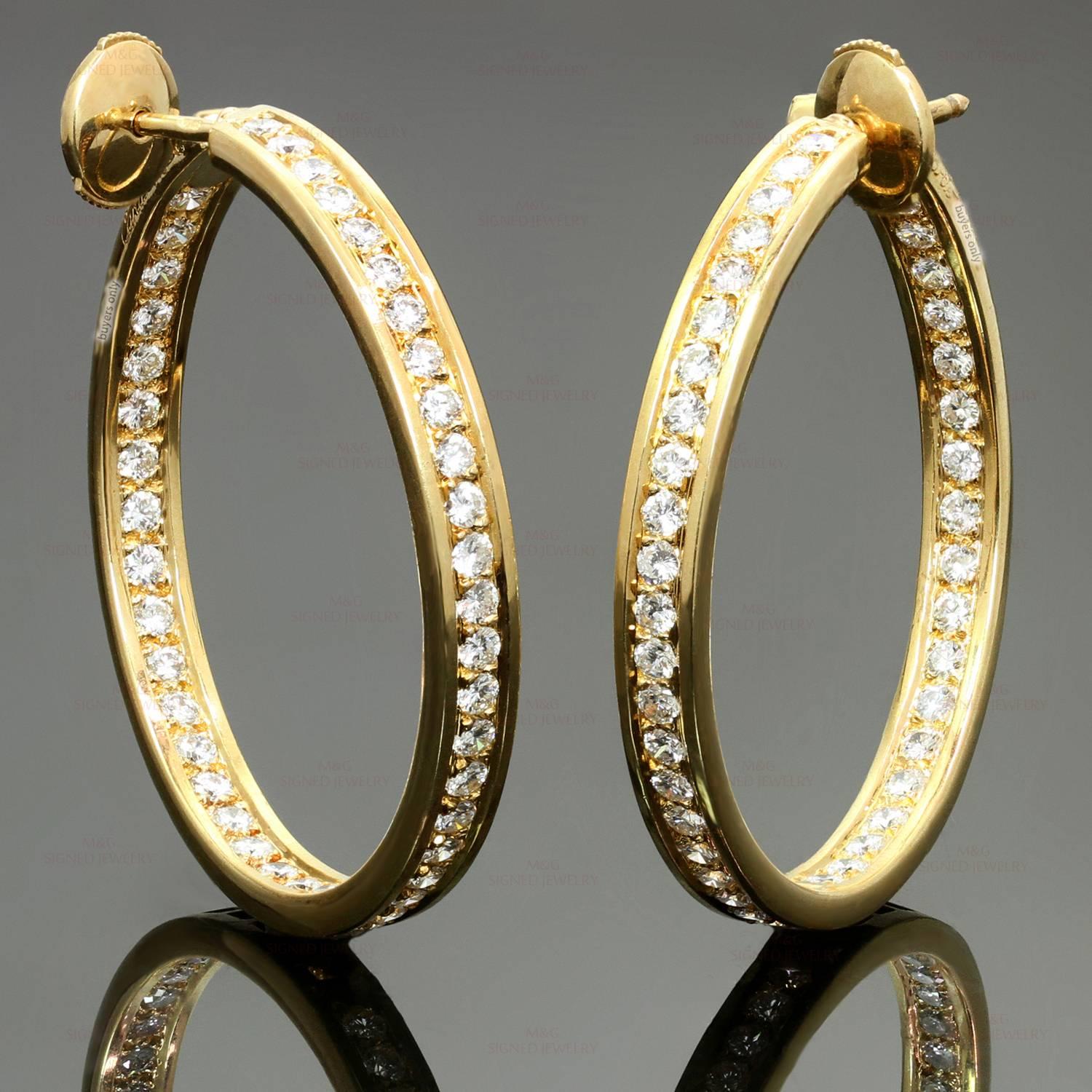 These magnificent Cartier hoop earrings featuring the unique inside out design are crafted in 18k yellow gold and set with brilliant-cut round diamonds of an estimated 2.94 carats. Made in France circa 1990s. Measurements: 0.15" (4mm) width,