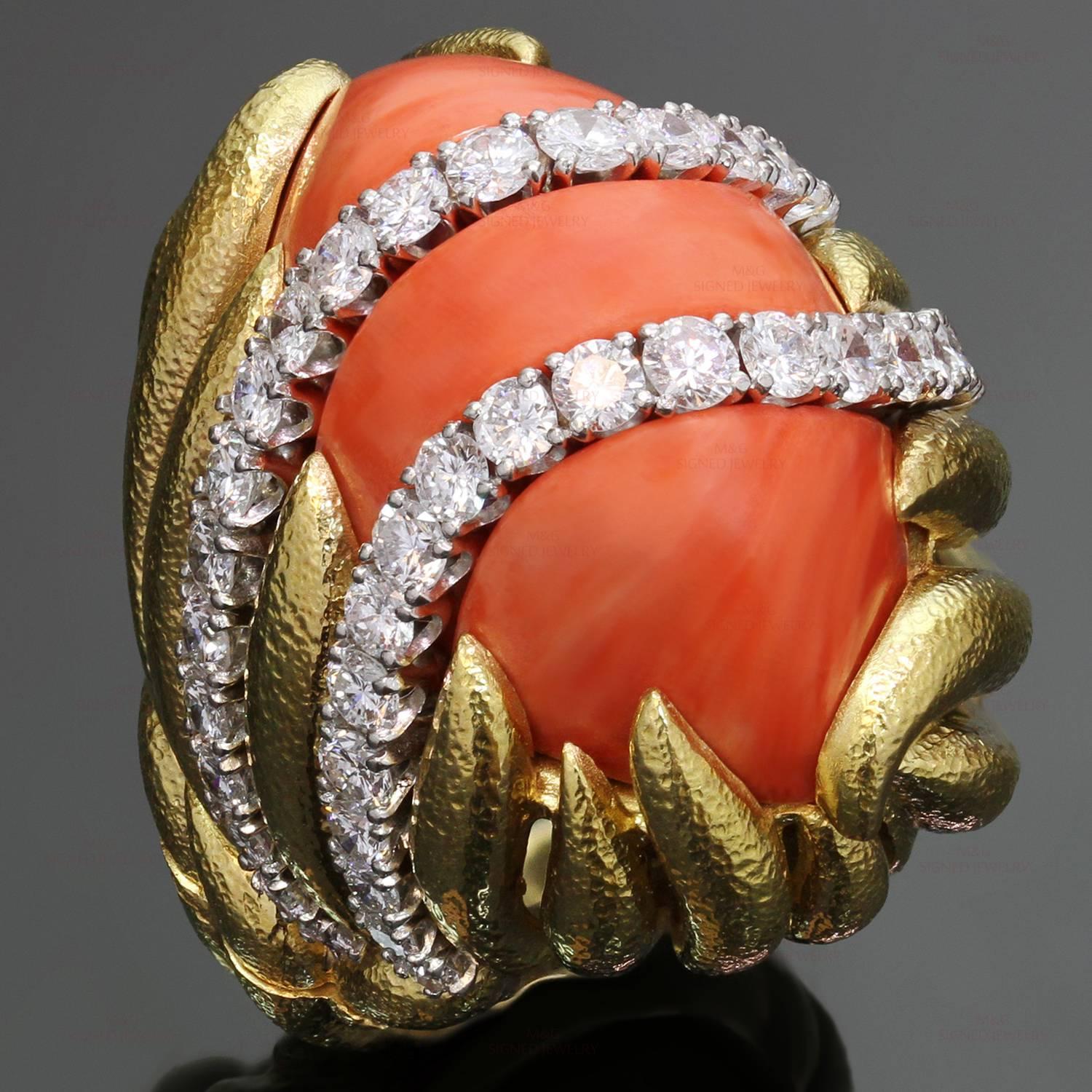 This gorgeous vintage David Webb cocktail ring is crafted in 18k yellow gold with platinum accents and set with a natural oval coral and brilliant-cut round diamonds of an estimated 1.0 carats. The ring size is adjustable with inner ring guard.
