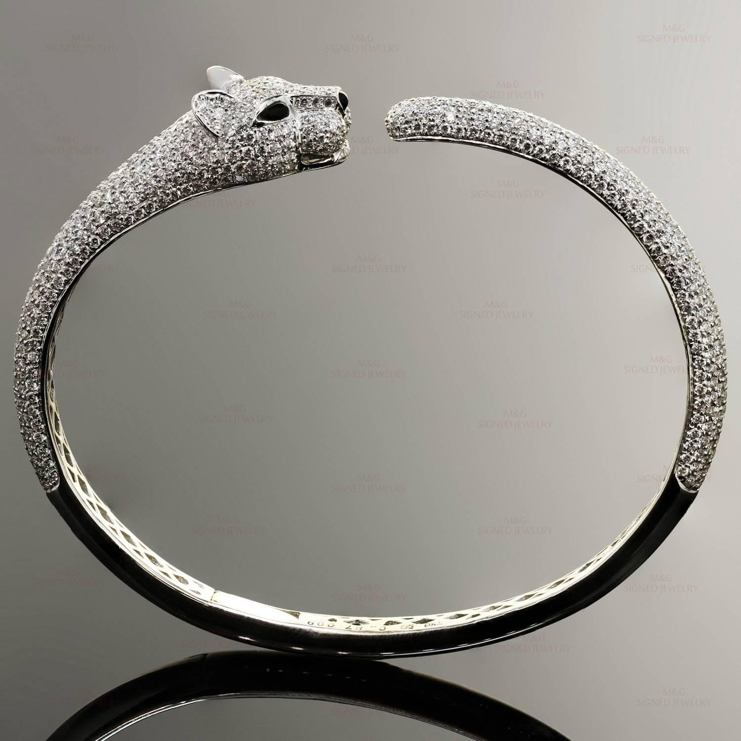 This gorgeous hinged bangle bracelet features a panther design crafted in 18k white gold and  black onyx eyes and approximately 600 round brilliant-cut diamonds of an estimated 4.90 carats. The inner length is 6 inches. Made in United States circa