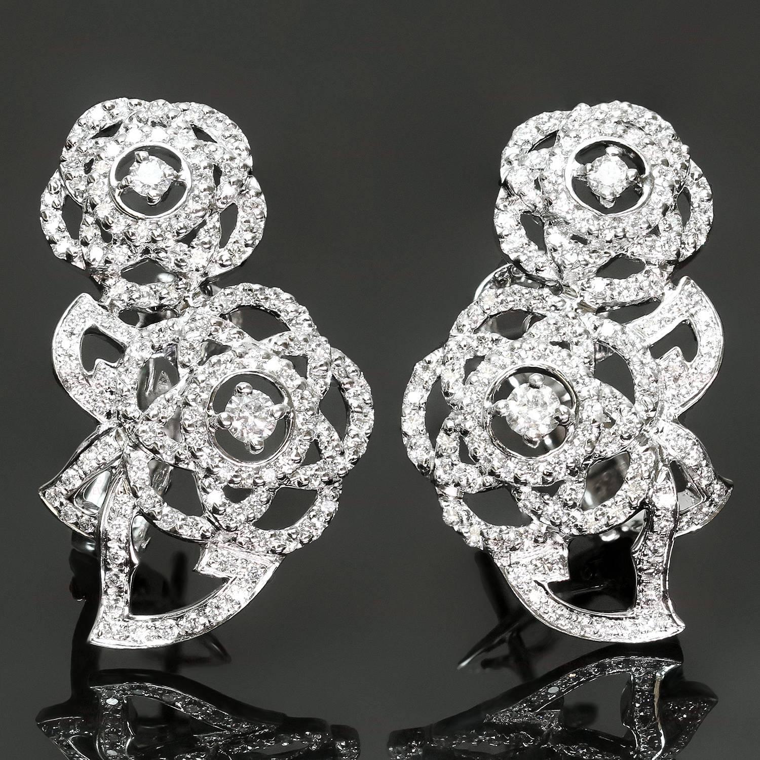 These magnificent Chanel earrings from the iconic Chamelia collection feature a delicate double flower design crafted in 18k white gold and set with brilliant-cut round diamonds. Made in France circa 2000s. Measurements: 0.70