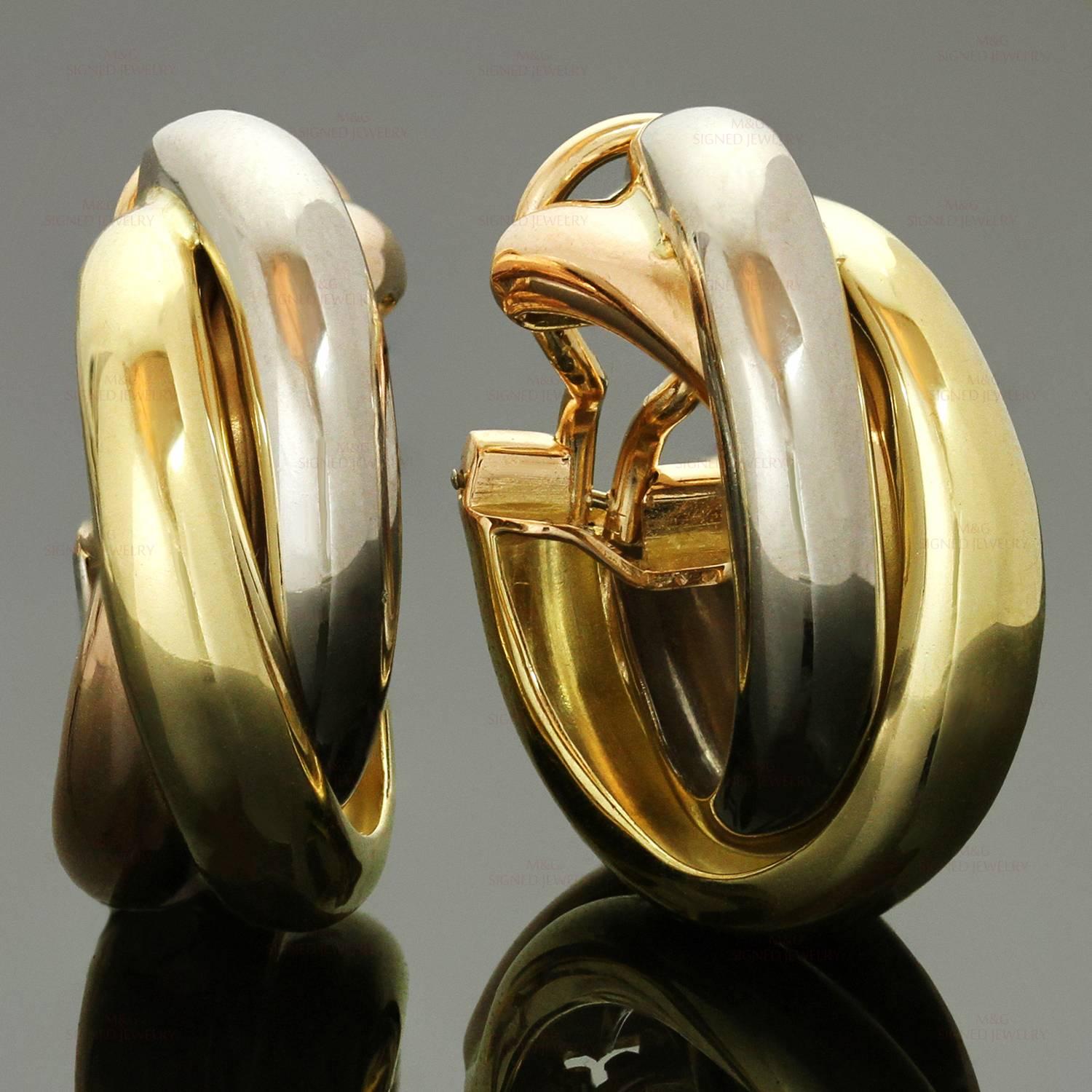 These classic earrings from Cartier's Trinity collection feature the perfect fusion of 18k yellow, white, and rose gold. Classic every day elegance. Made in France circa 2000s. Measurements: 0.38