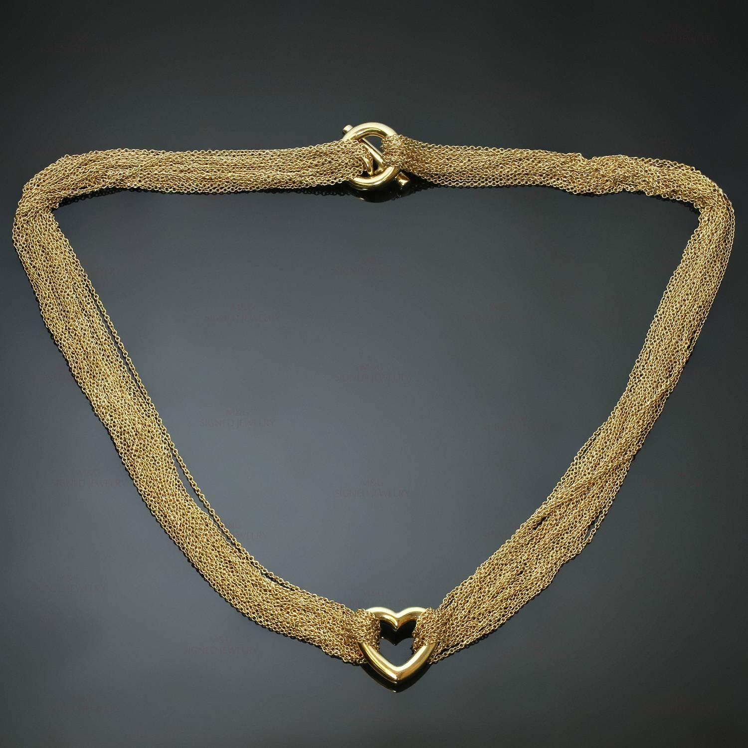 This iconic Tiffany necklace is crafted 18k yellow gold and features a multistrand petite rolo mesh chain accented with a heart pendant and completed with a toggle closure. Made in United States circa 1990s. Measurements: 16