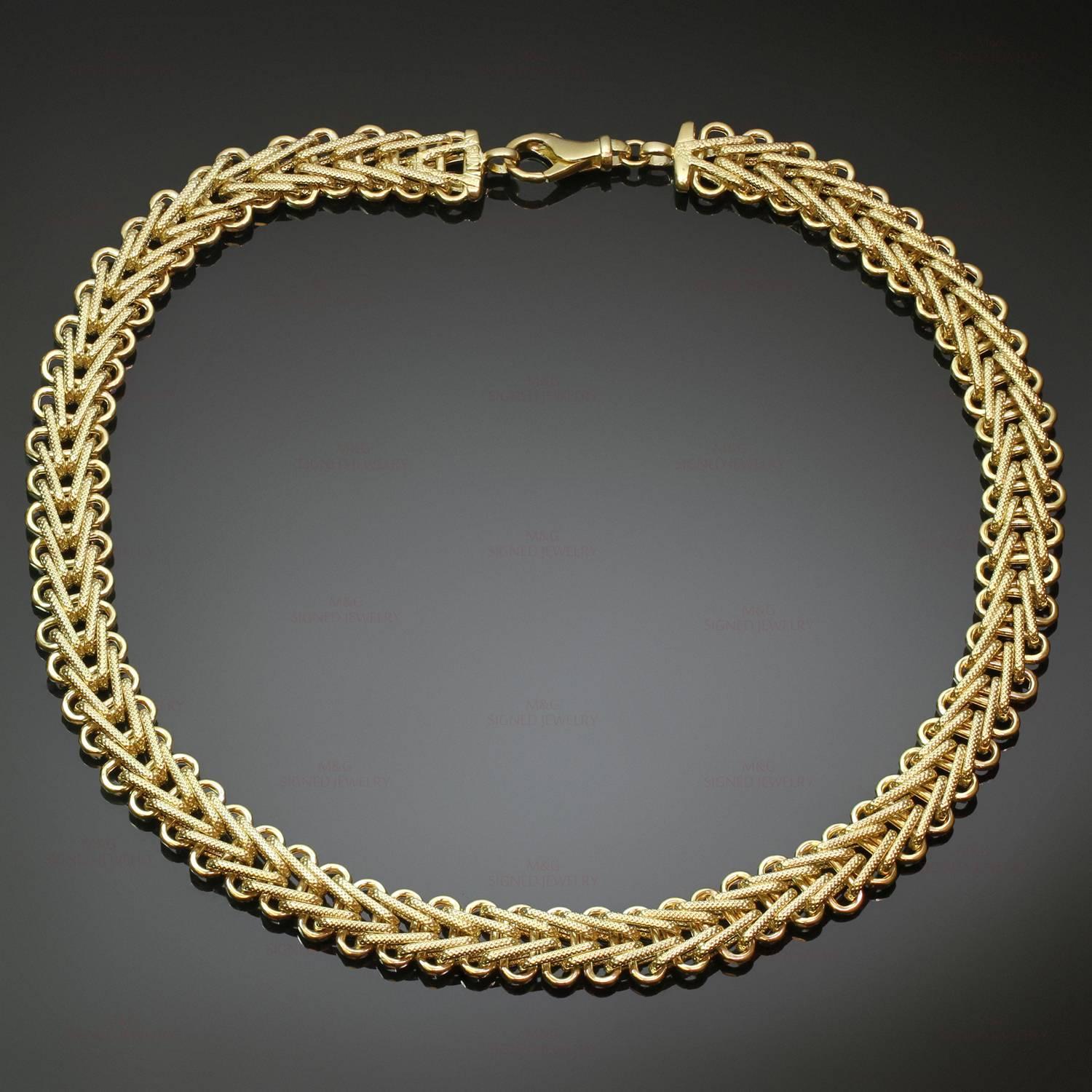 This stunning retro estate necklace features a wide braided design crafted 14k yellow gold and completed with a lobster claw clasp. Made in United States circa 1980s. Measurements: 0.47