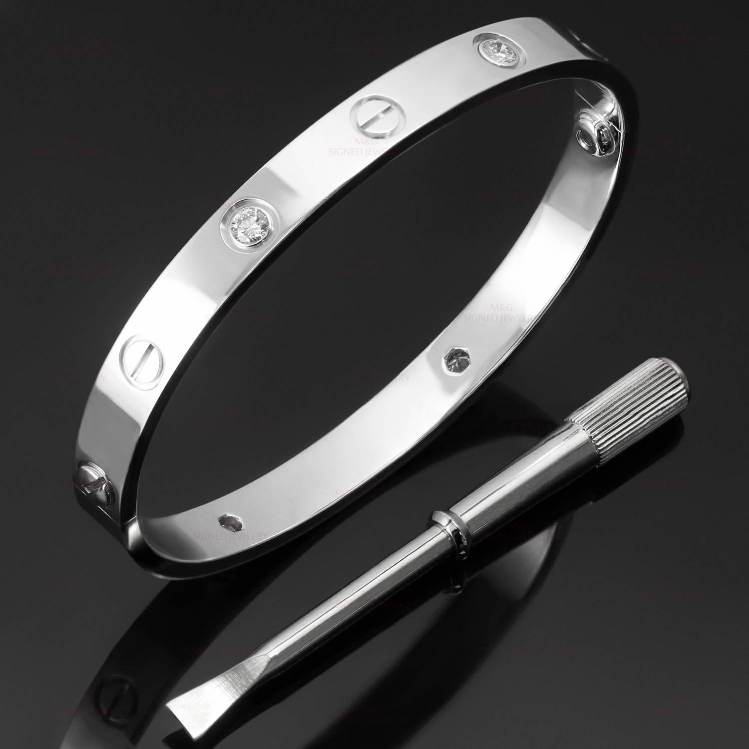This iconic and timeless bracelet from Cartier's Love collection is crafted in 18k white gold and set with 4 round brilliant-cut diamonds. Completed with the original Cartier screwdriver, box, and papers. This bangle is a size 16.