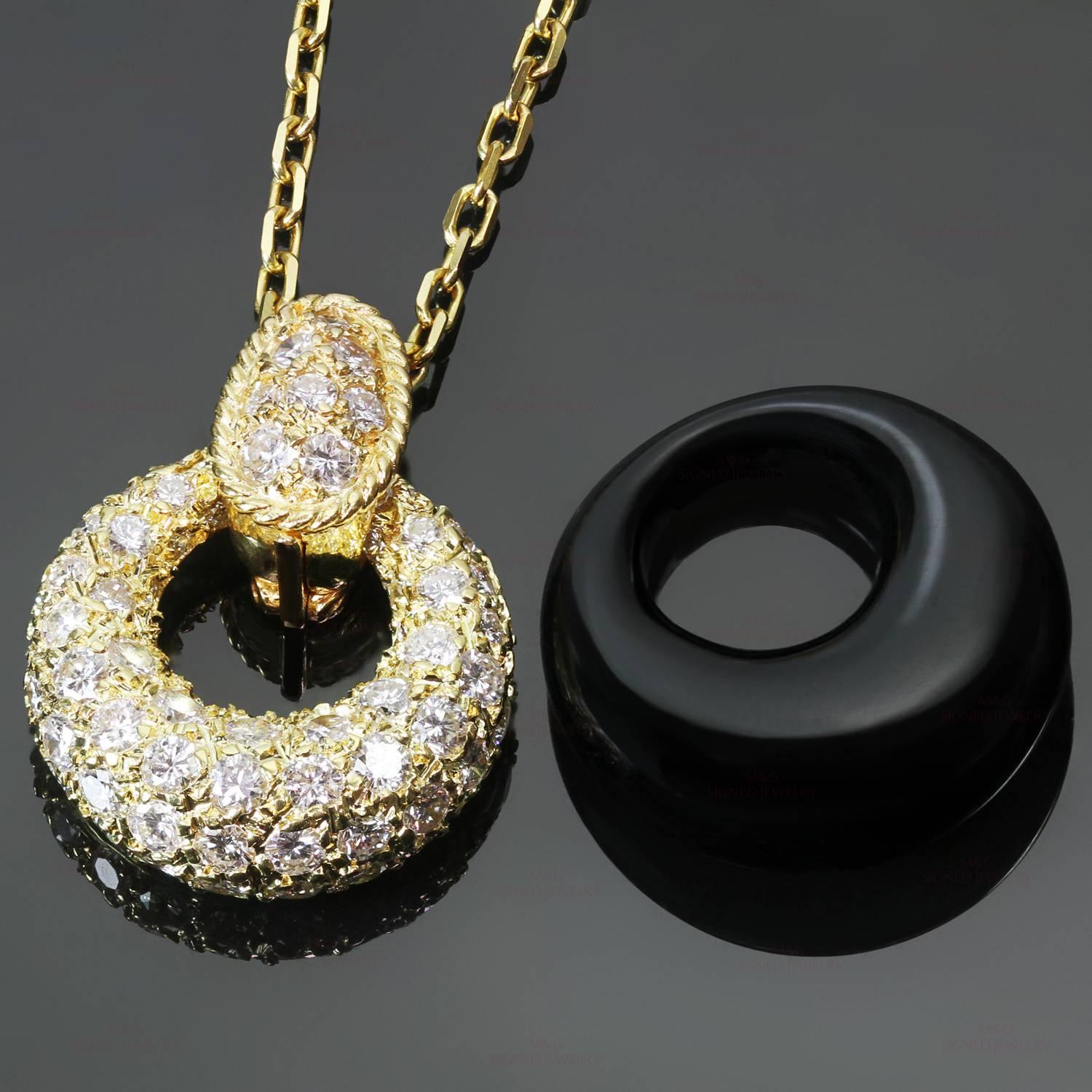 This classic circa 1970s Van Cleef & Arpels necklace is crafted in 18k yellow gold and features a versatile pendant enhancer completed with 2 circular pendants made of onyx and sparkling pave diamond gold. The enhancer and the pendant weight are set