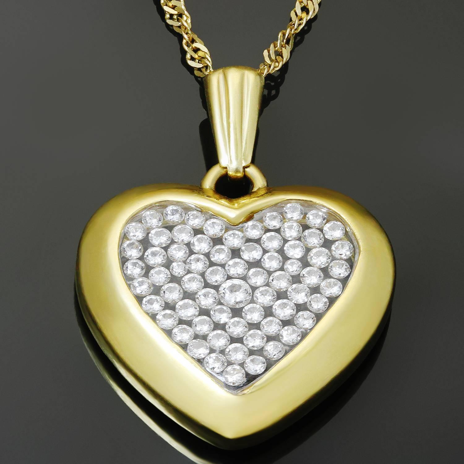 This romantic vintage necklace is crafted in 18k yellow gold and features a heart-shaped pendant accented with brilliant-cut round diamonds of an estimated 0.60 carats set in crystal case. Made in United States circa 1980s.  Measurements: 0.70"