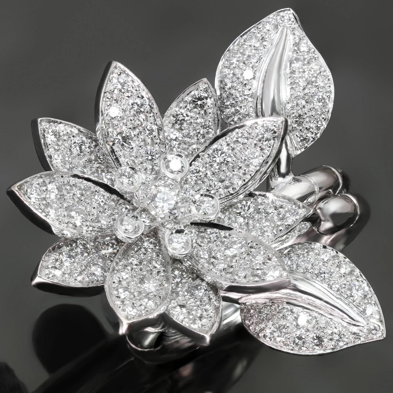 This fabulous Van Cleef & Arpels ring is crafted in 18k white gold and features a gorgeous lotus flower design set with 127 brilliant-cut round diamonds of an estimated 2.13 carats. This between-the-finger ring can be worn on either one or two