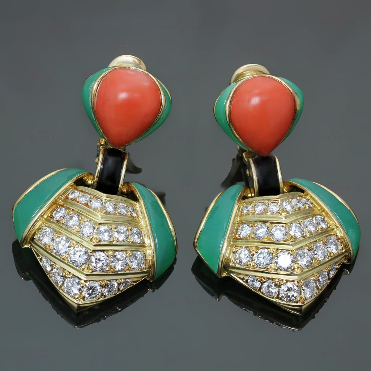 These magnificent Van Cleef & Arpels clip-on earrings are made in 18k yellow gold and feature geometric drops set with 4 rows of brilliant-cut round E-F VVS2-VS1 diamonds of an estimated 3.0 carats, green chrysoprase side stones, red coral, and