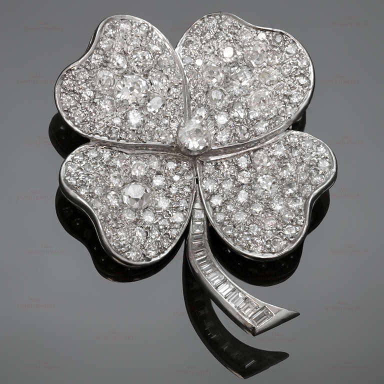 Magnificent Art Deco 18k White Gold Diamond Flower Brooch Pin
This stunning vintage 4-petal flower-shaped brooch is made in 18k white gold and set with approximately 125 round, baguette-cut, and old-mine cut sparkling  diamonds. Estimated carat