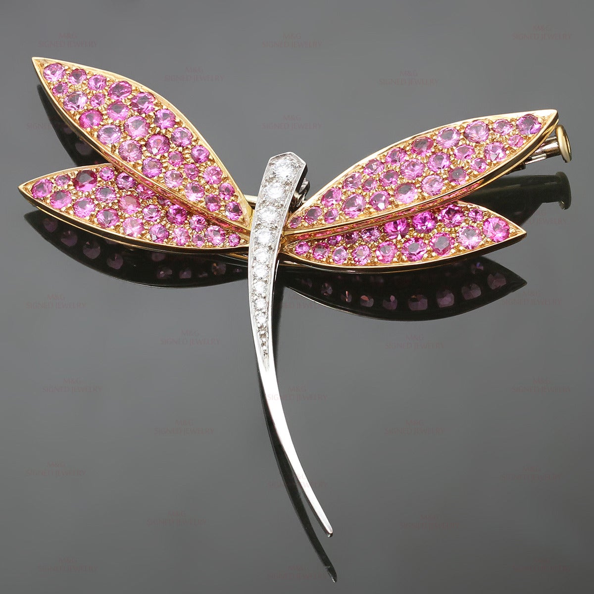 This magnificent Van Cleef & Arpels brooch is crafted in the shape of a dragonfly and set with faceted pink sapphire wings in 18k rose gold and brilliant-cut round white diamond body in 18k white gold. The D-E VVS1-VVS2 diamonds weigh an estimated