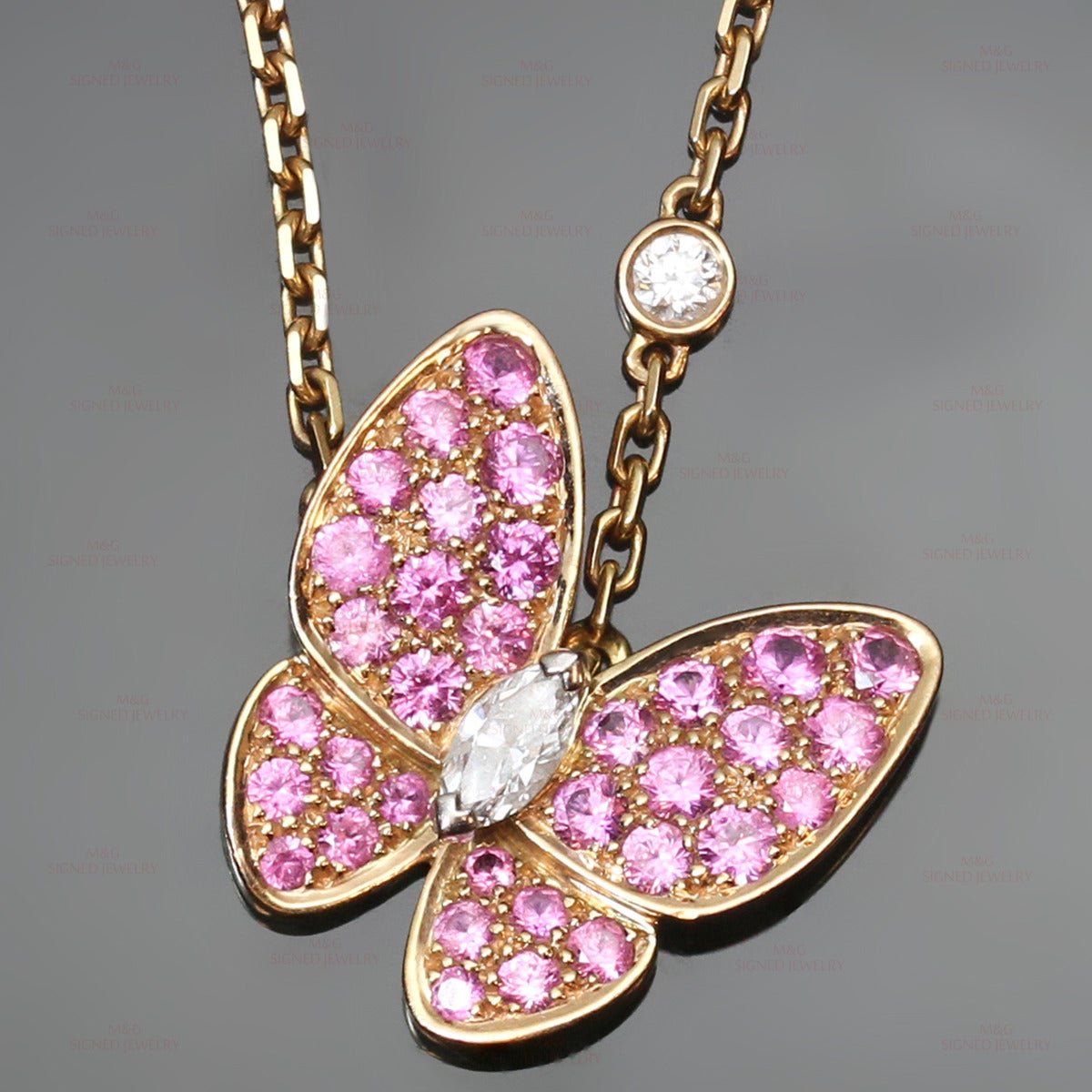 This fabulous Van Cleef & Arpels necklace is made in 18k yellow gold and features an elegant butterfly pendant set with marquise-cut D-F VVS1-VVS2 diamonds of an estimated 0.17 carats and faceted round pink sapphires of an estimated 1.45 carats.