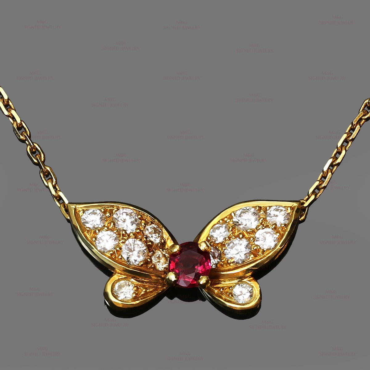 This stunning Van Cleef & Arpels necklace is made in 18k yellow gold and set a round faceted red ruby of an estimated 0.38 carats and round brilliant-cut D-F VVS1-VVS2 diamonds of an estimated 0.55 carats. Made in France circa 1990s. Measurements: