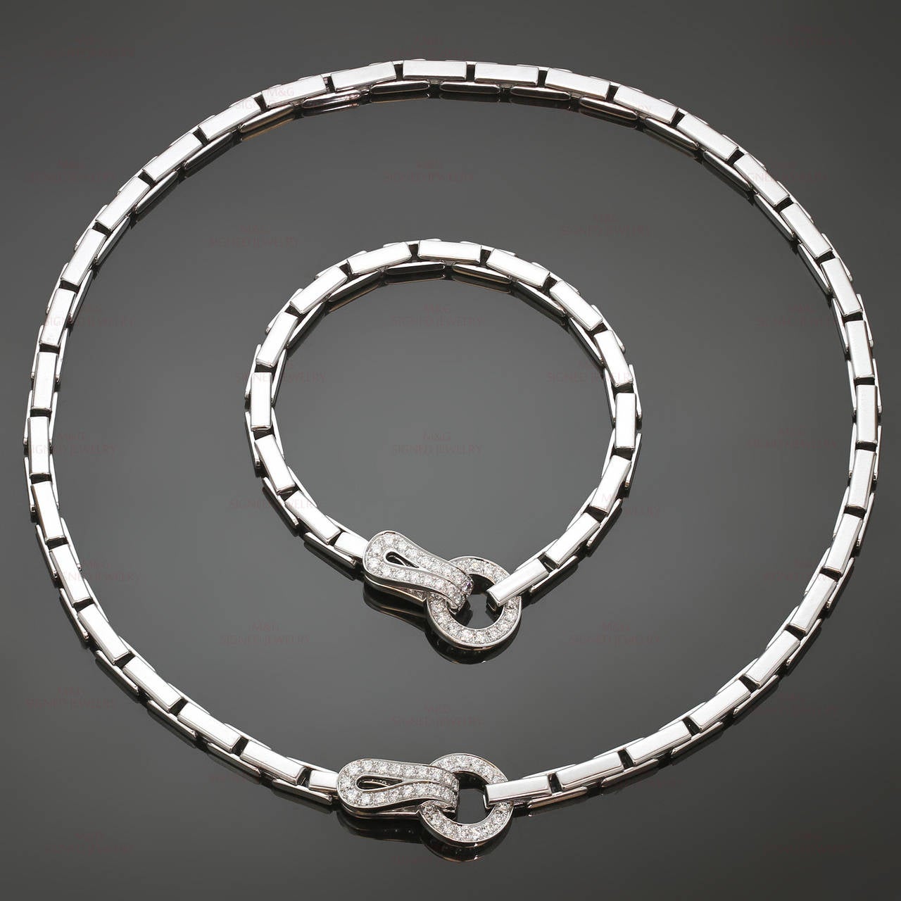 This modern Cartier necklace and bracelet set from the classic Agrafe collection is made in 18k white gold and set with brilliant-cut round D-F VVS1-VVS2 diamonds - an estimated 1.40 carats in the necklace and 1.30 carats in the bracelet. Simply