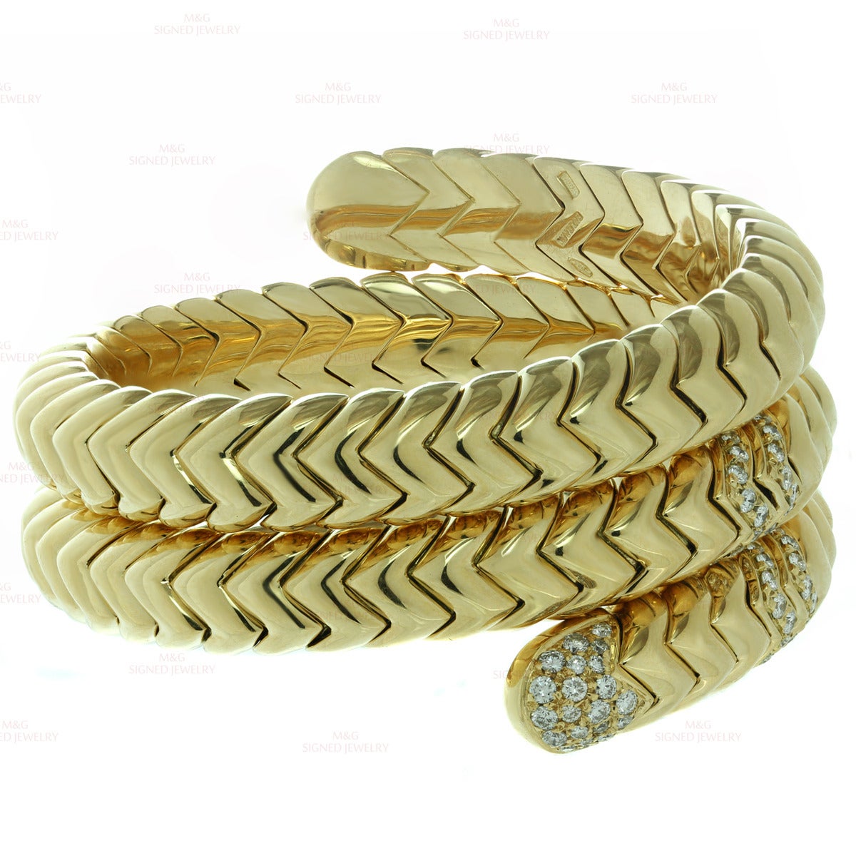 This stunning bracelet from Bulgari's Spiga collection features a flexible 3-row geometric design made in 18k yellow gold and set with brilliant-cut round E-F VVS1-VVS2 diamonds of an estimated 3 carats. Made in Italy circa 1990s. Measurements: