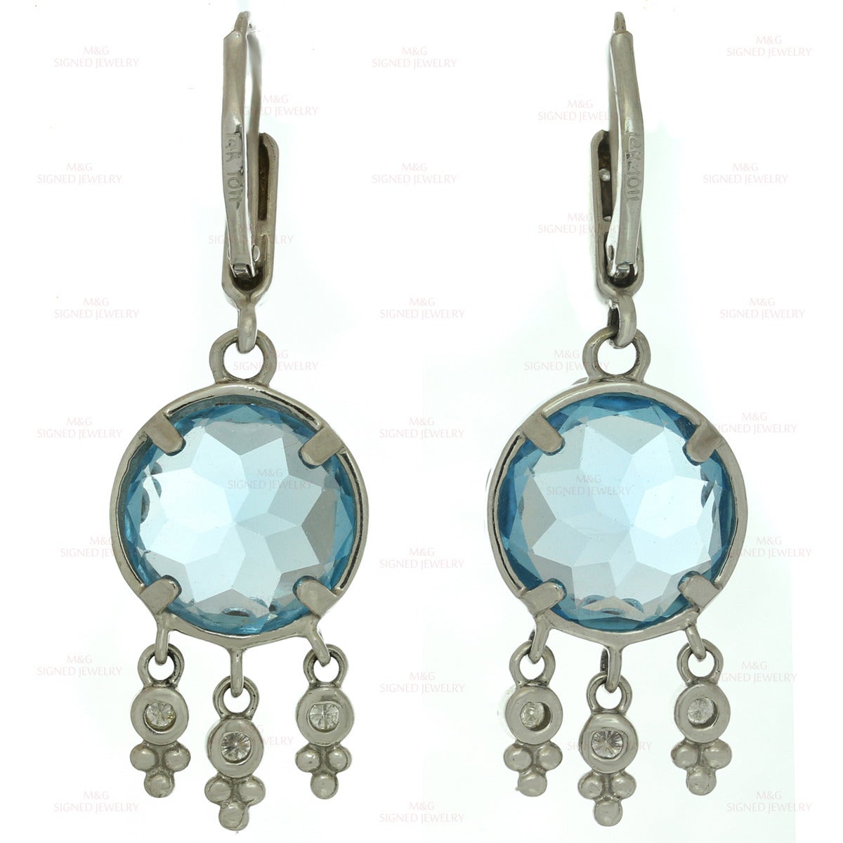 These classic drop earrings are crafted in 14k white gold and feature faceted round blue quartz stones accented set with round brilliant-cut H-I VS2-SI1 diamonds of an estimated 0.90 carats. Made in United States circa 2000s. Measurements: