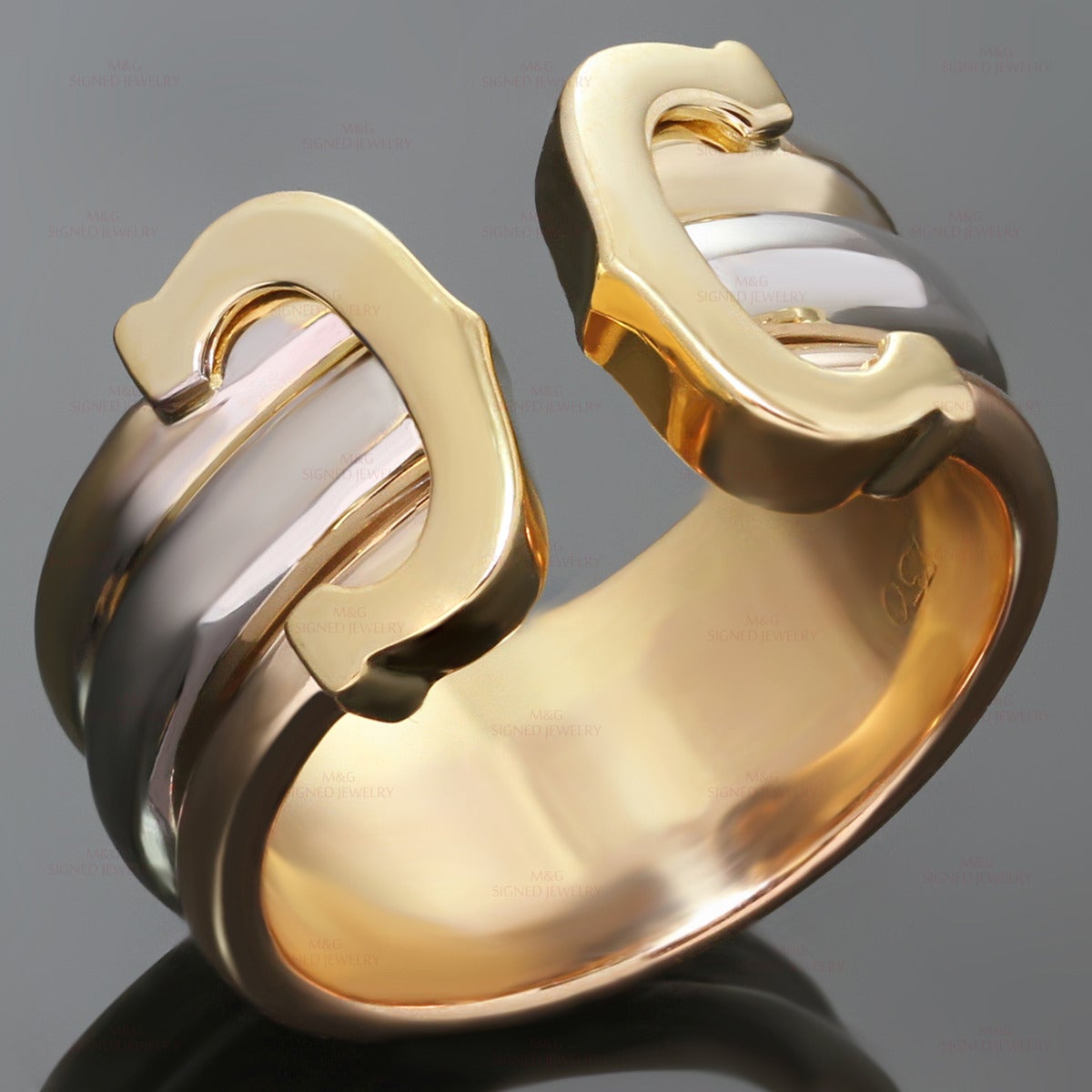 This elegant open band Cartier ring features 3-band design crafted in 18k yellow, white, and rose gold and completed with the iconic Double C tips in yellow gold. Made in France circa 1990s. Measurements: 0.43