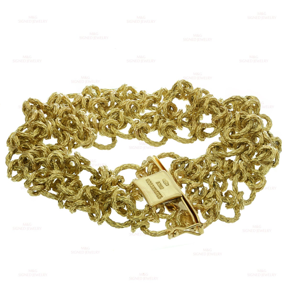 This extremely rare Tiffany bracelet features an intricate chain link design beautifully crafted in textured 18k yellow gold. Made in France circa 1950s. Measurements: 1.02