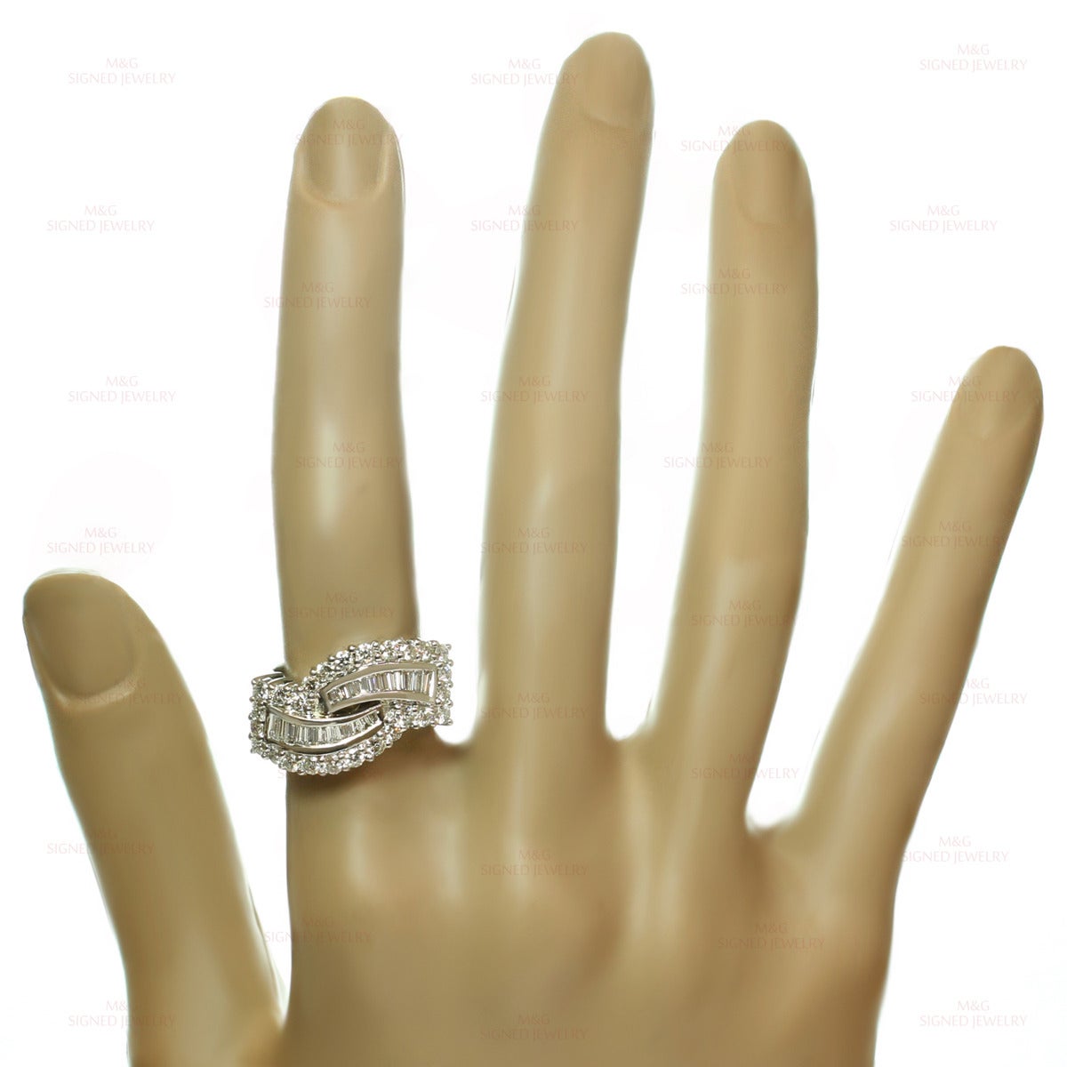 This elegant ring is crafted in 18k white gold and beautifully set G-H VS1-VS2 diamonds, 20 baguette-cut and 26 round brilliant-cut diamonds of an estimated 1.94 carats. Made in United States circa 1990s. Measurements: 0.51