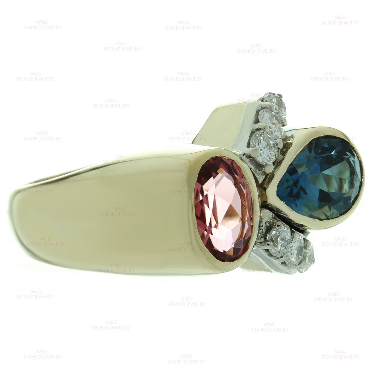 This elegant ring is crafted in 14k yellow gold and set with a faceted pink tourmaline of an estimated 1.20 carats,  a faceted London blue topaz of an estimated 1.50 carats, and round brilliant-cut G-H VS1-VS2 diamonds of an estimated 0.40 carats.
