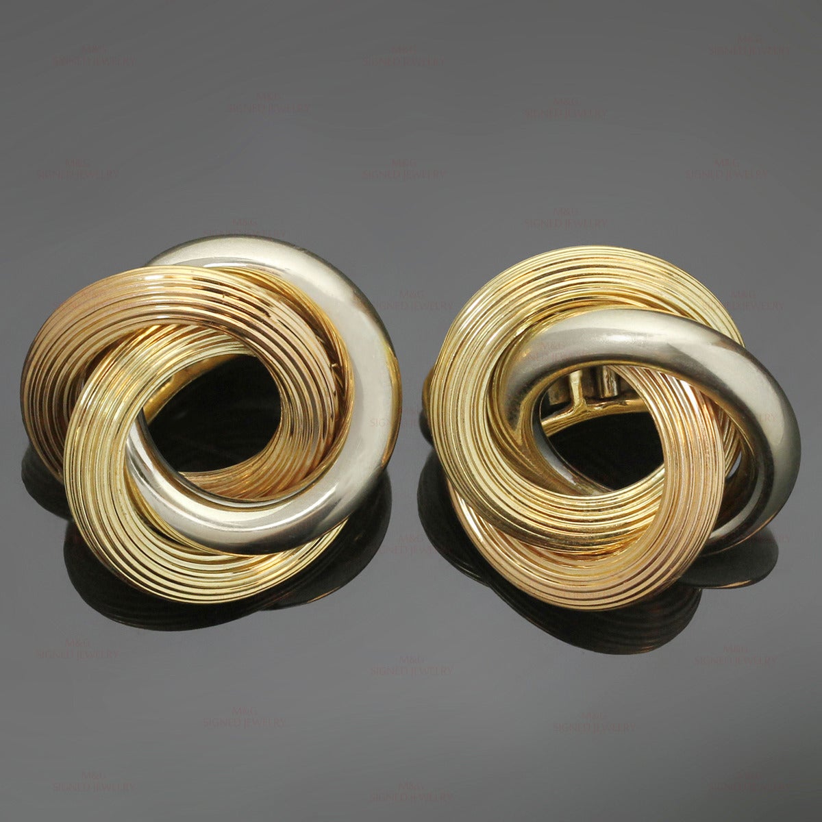 These classic Bvlgari clip-on earrings feature 3 intertwined ridged loops crafted in 18k yellow, white, and rose gold. Made in Italy circa 1950s. Measurements: 1.02