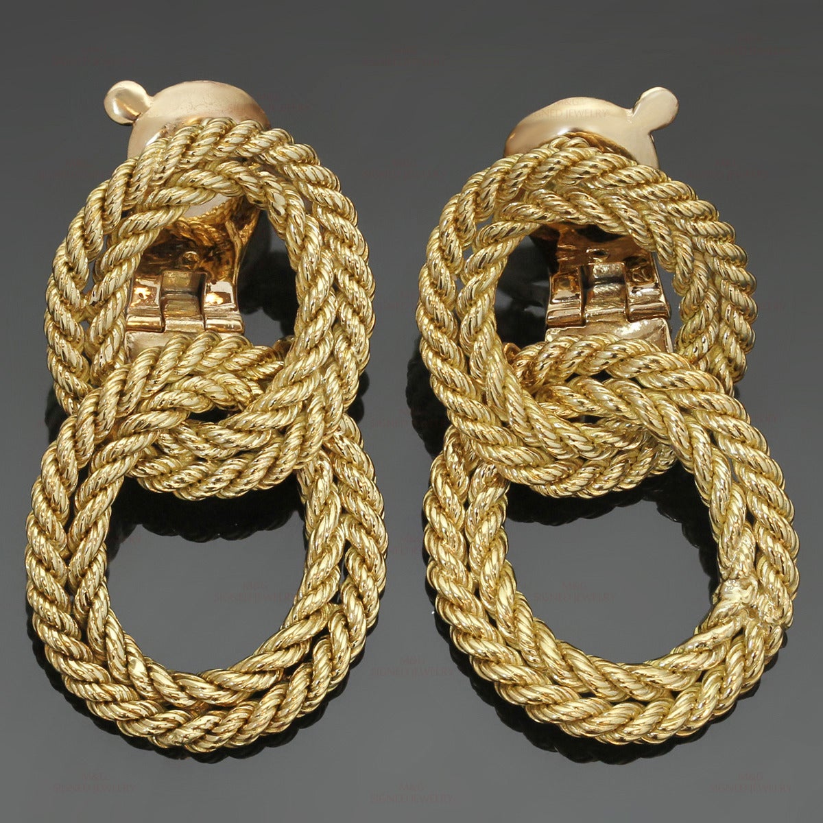 These fabulous vintage Tiffany & Co. clip-on earrings feature a door-knocker design composed of oval braided loops crafted in 18k yellow gold. Made in France circa 1950s. Measurements: 0.90