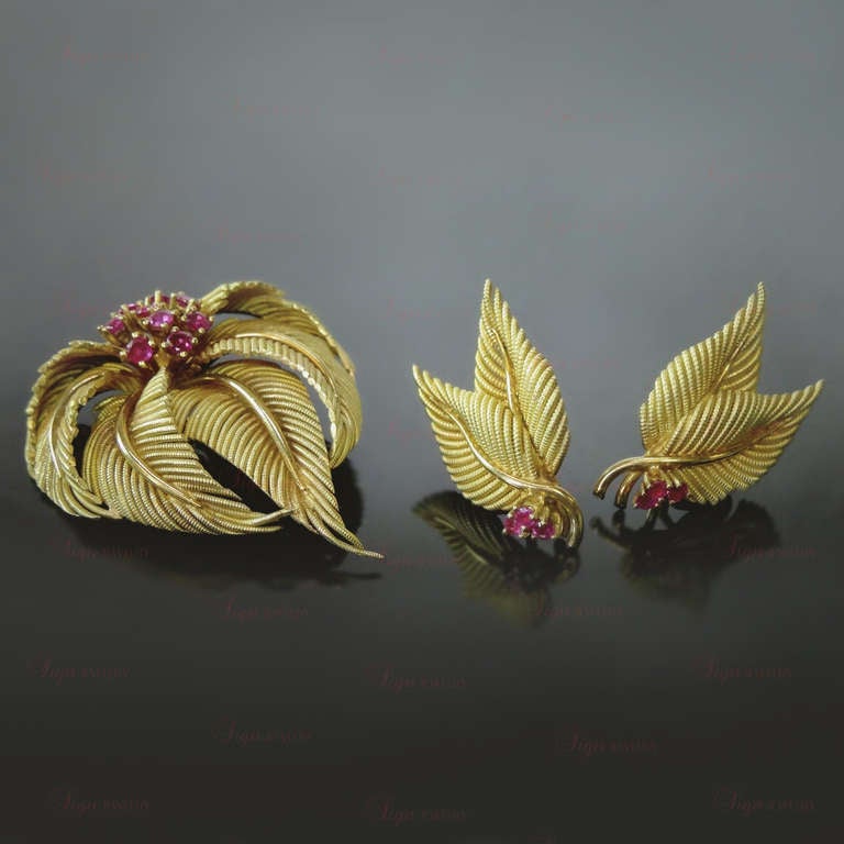 A dazzling jewelry set from Tiffany & Co. featuring an intricately timeless leaf-cluster design. This authentic 39mm x 53mm brooch and a pair of matching clip-on 20mm x 32mm earrings are made in 18k yellow gold and prong-set with an estimated 2